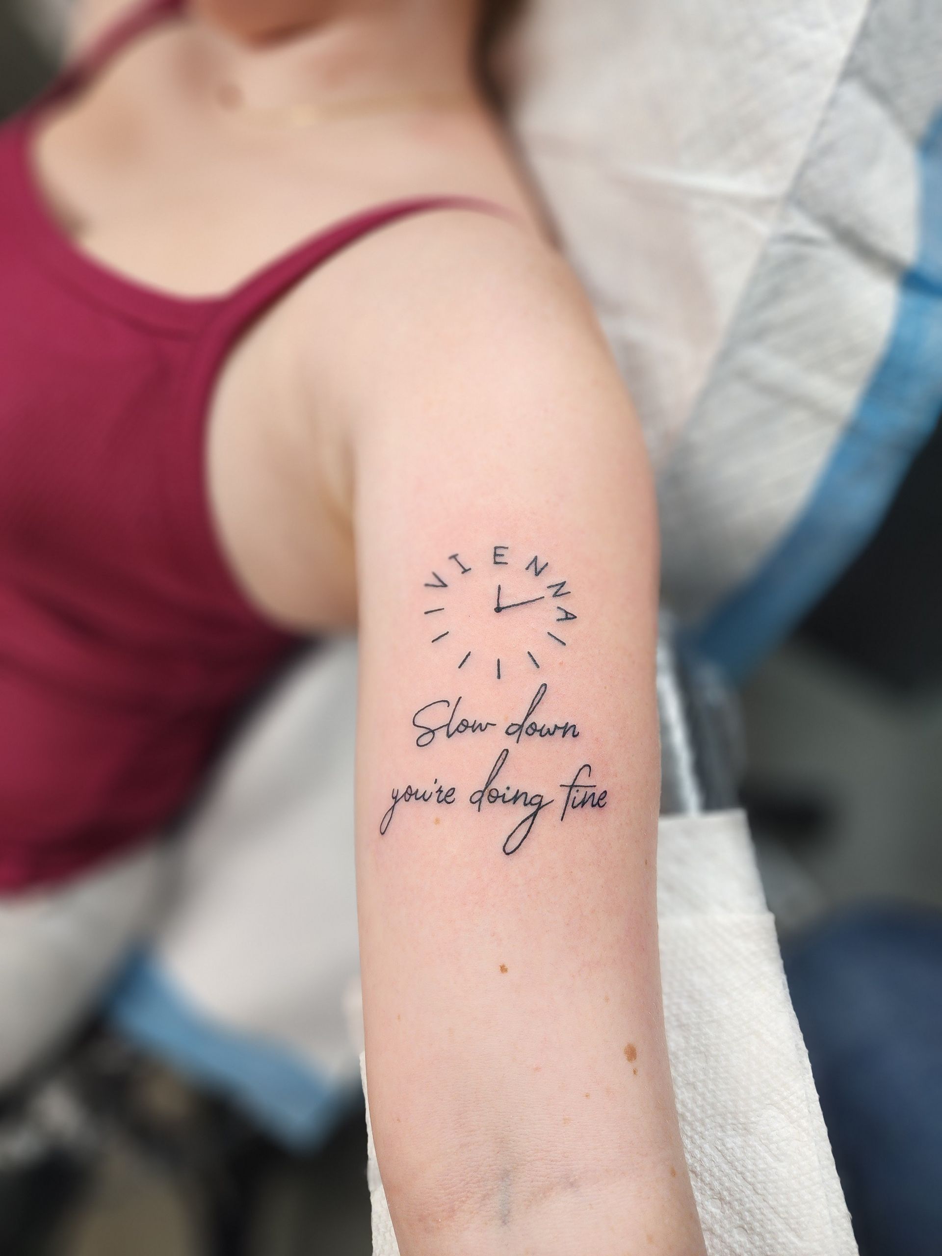 Tattoo of a clock outline with the text