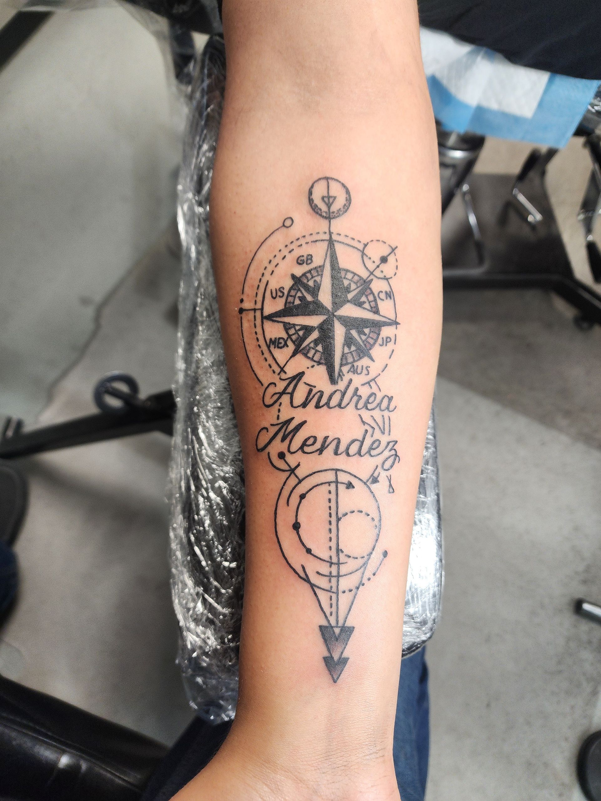 Tattoo of a compass rose with the name