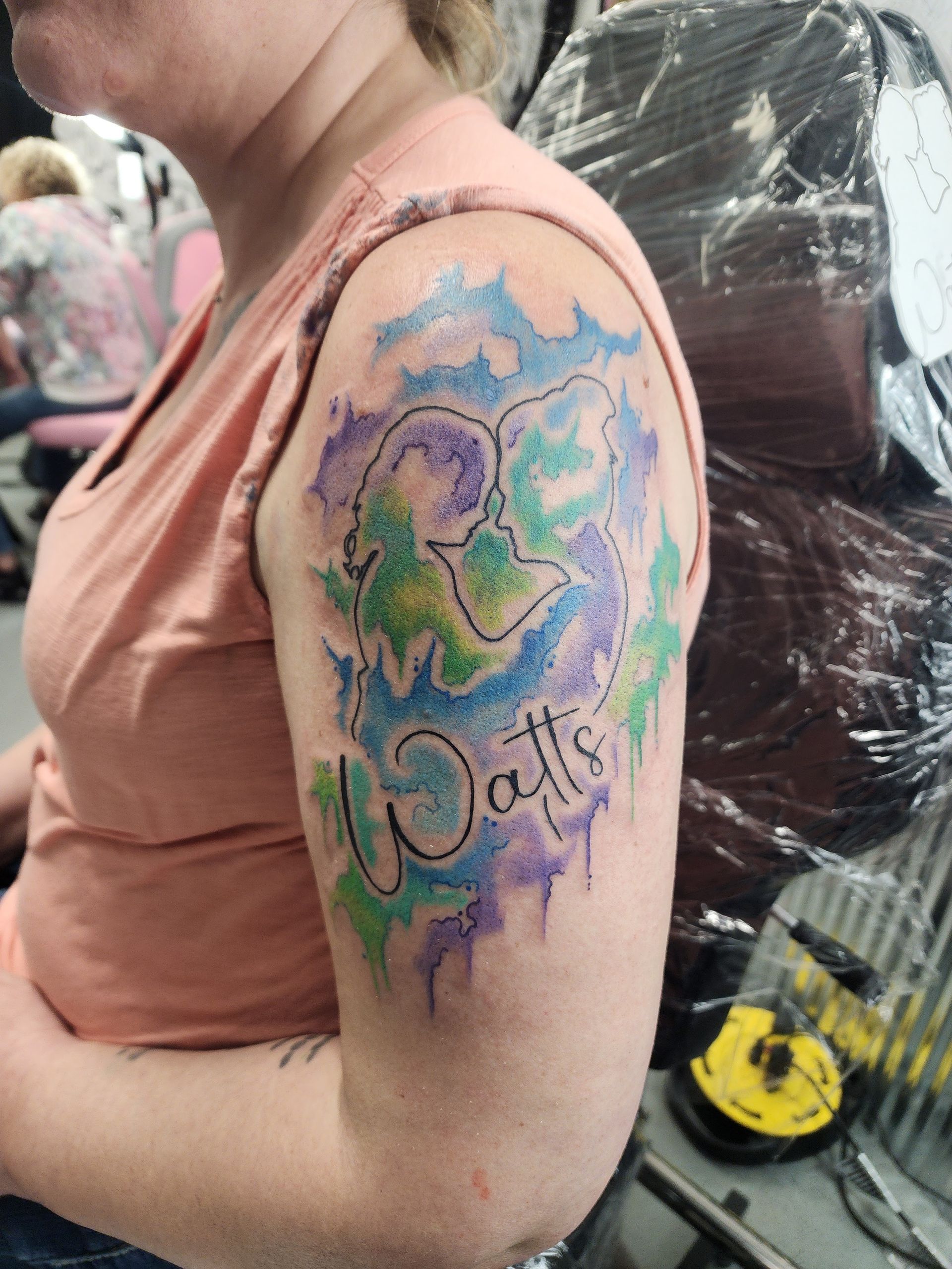 Tattoo of two silhouettes and the name