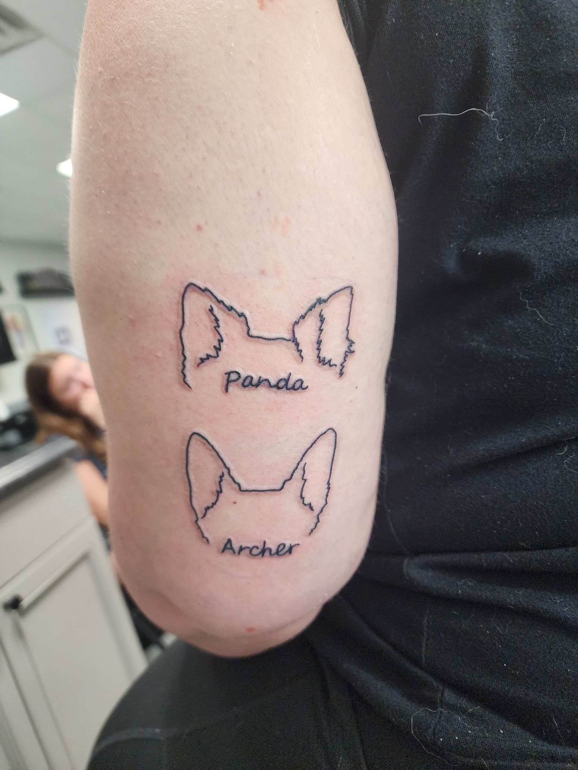 Tattoo of two dog ear outlines with names