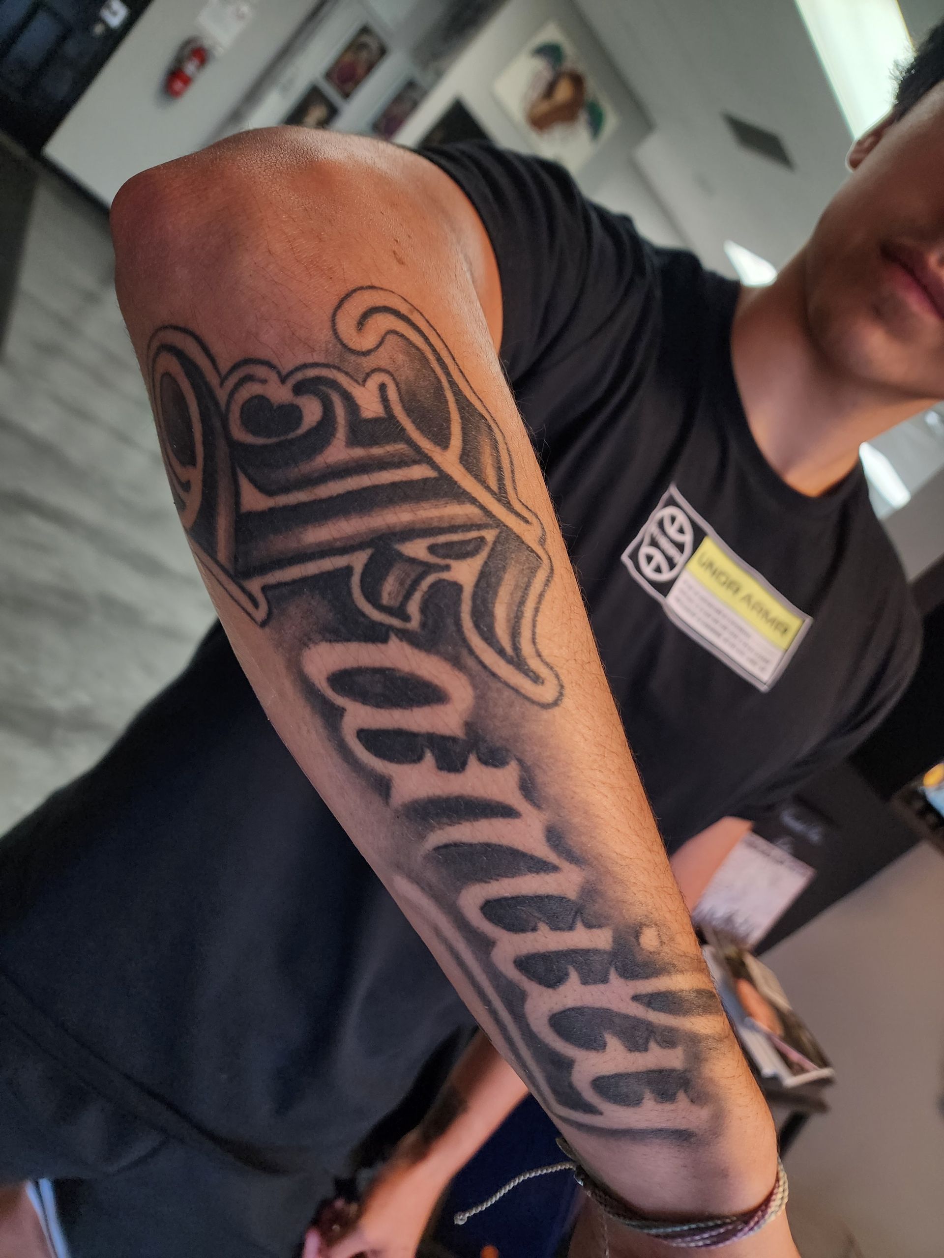Man's arm with a tattoo of the name