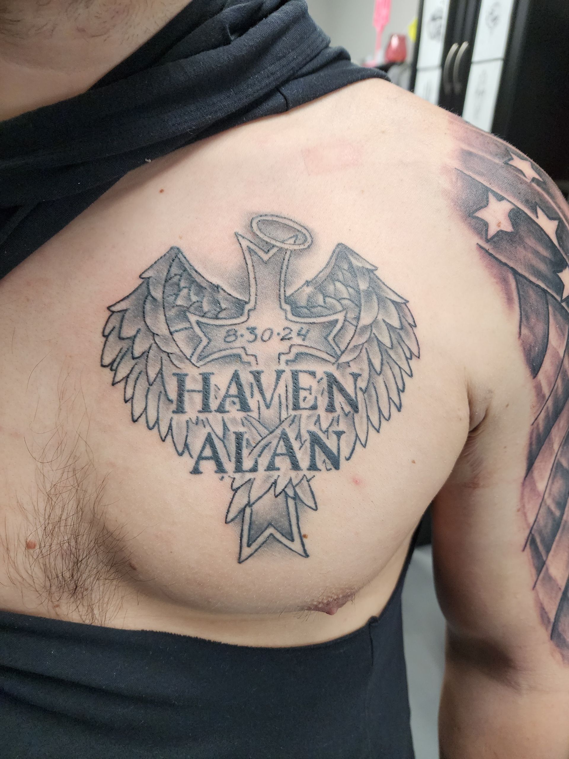 Tattoo of a cross with wings and the name