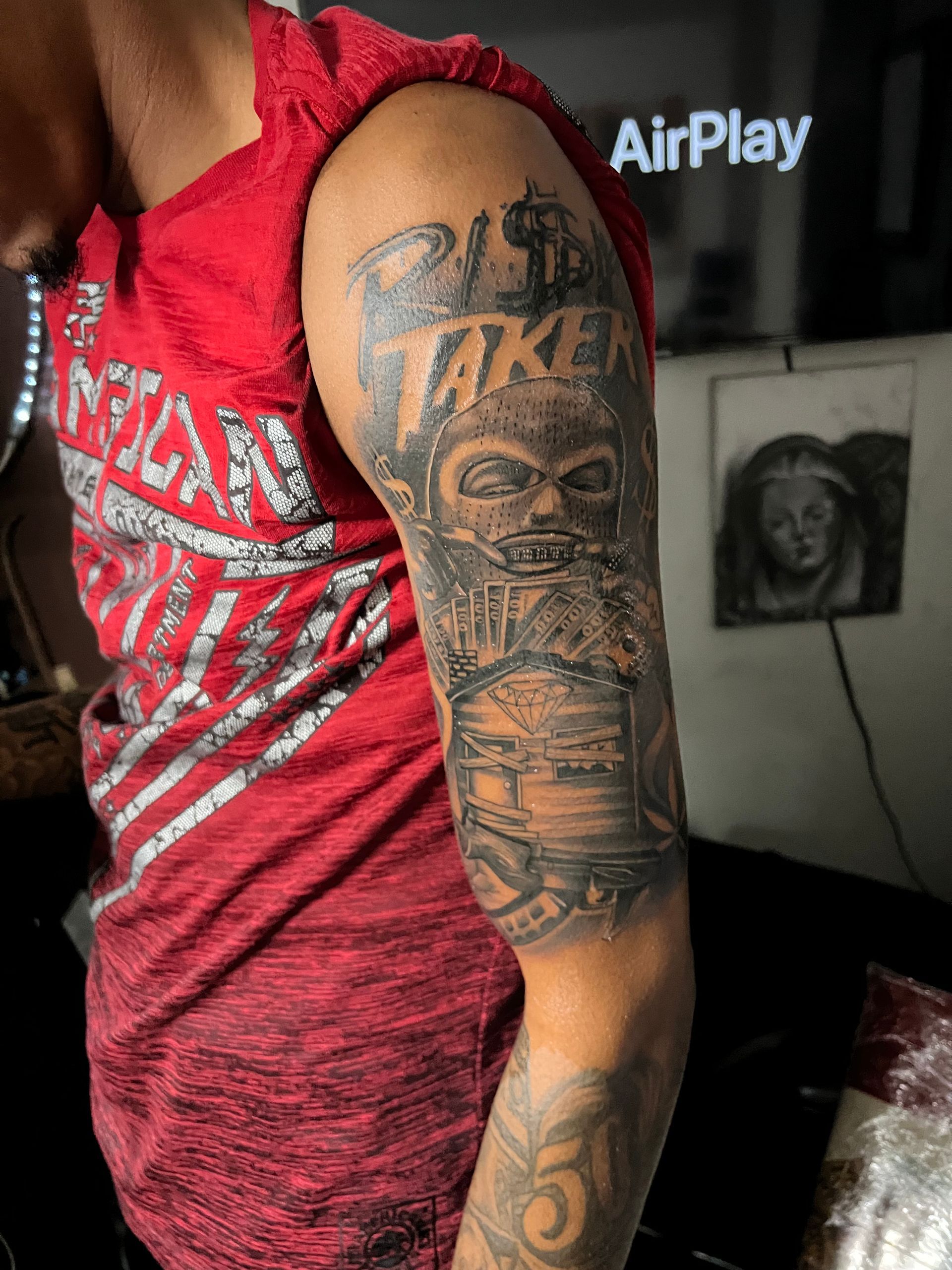 Man with a sleeve tattoo of a tomb, a skull, and the word