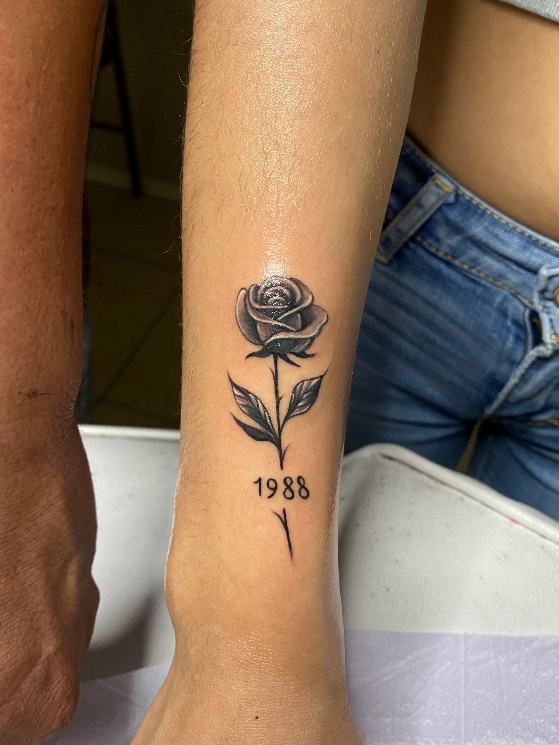 Black rose tattoo with the year
