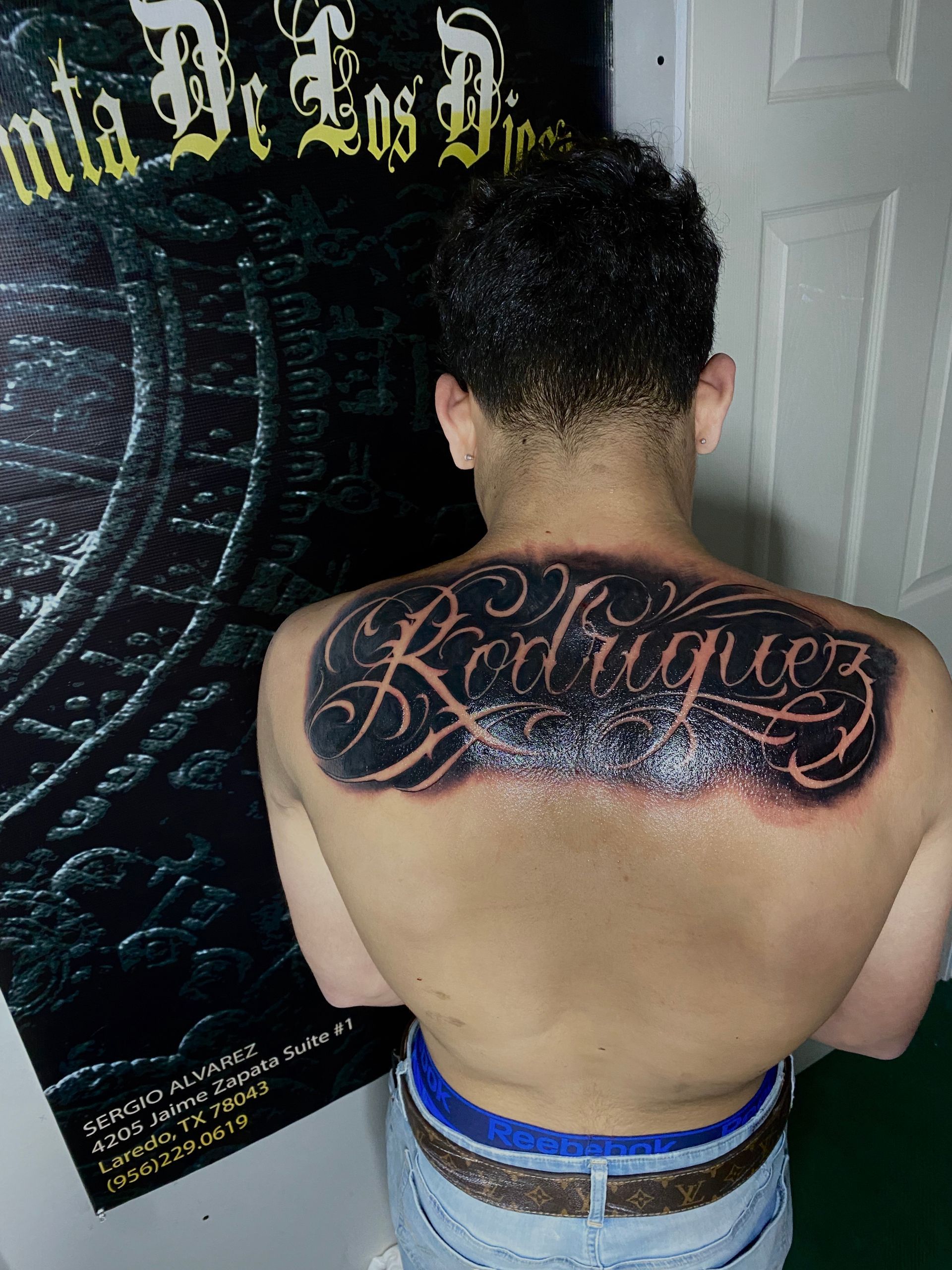 Man with a large black tattoo of the surname