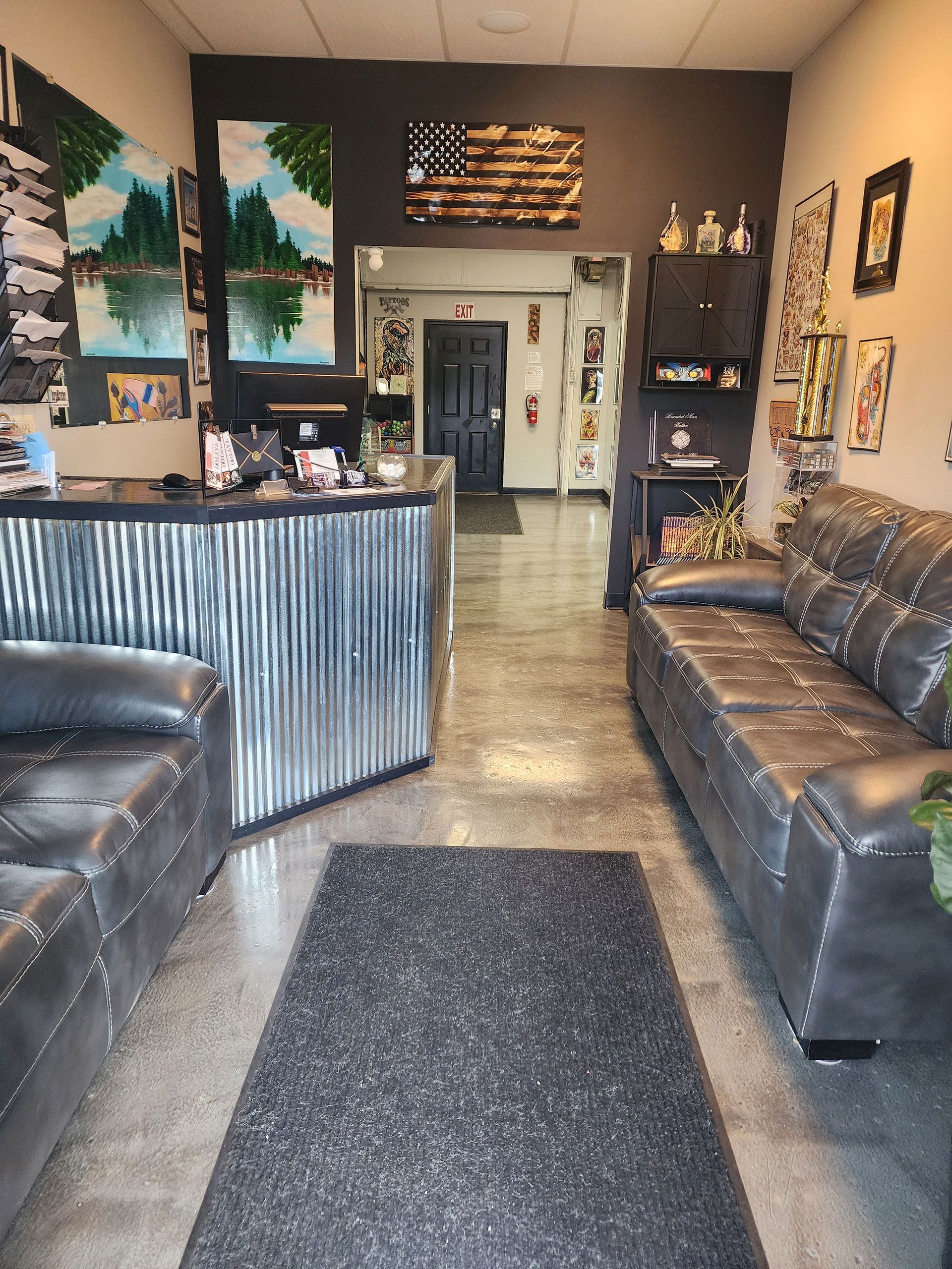 A waiting room with a couch, chairs and a counter