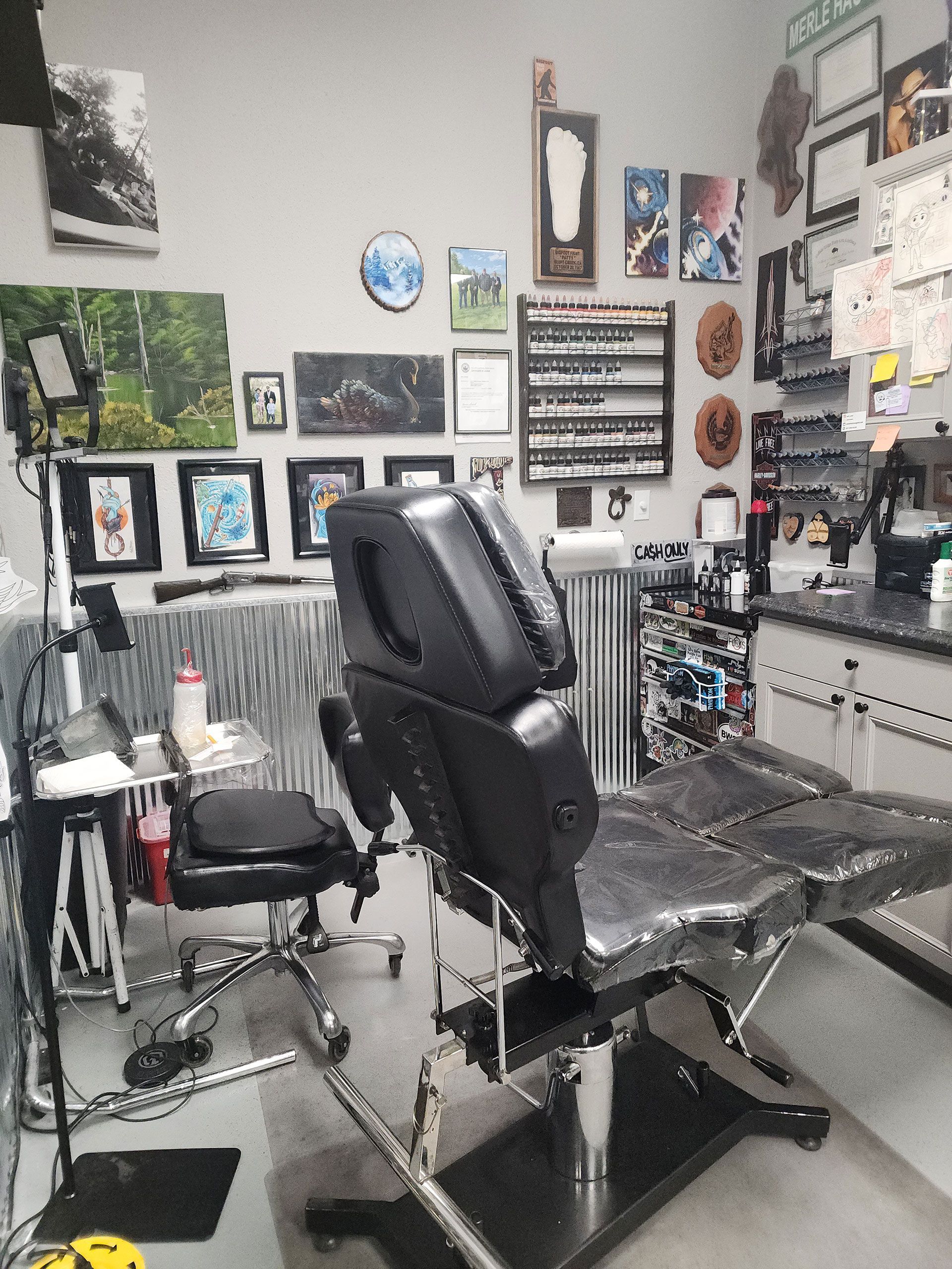 A tattoo studio with a chair and a table