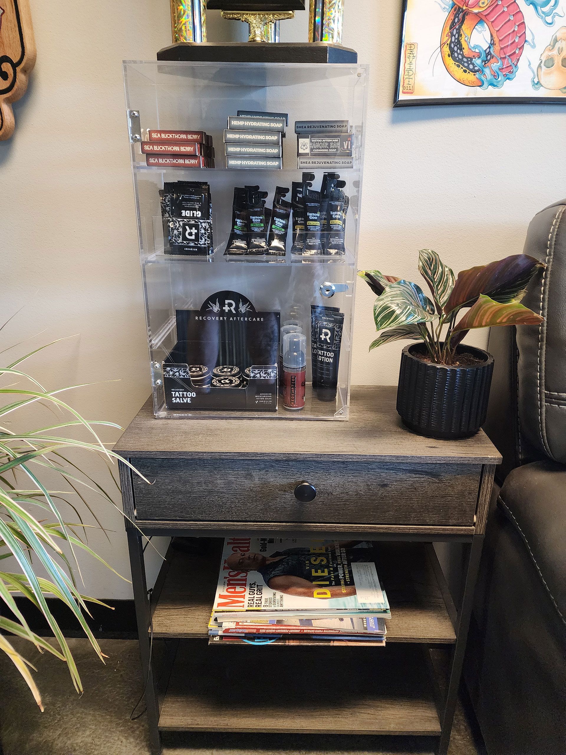 A small table with a drawer and a clear display case