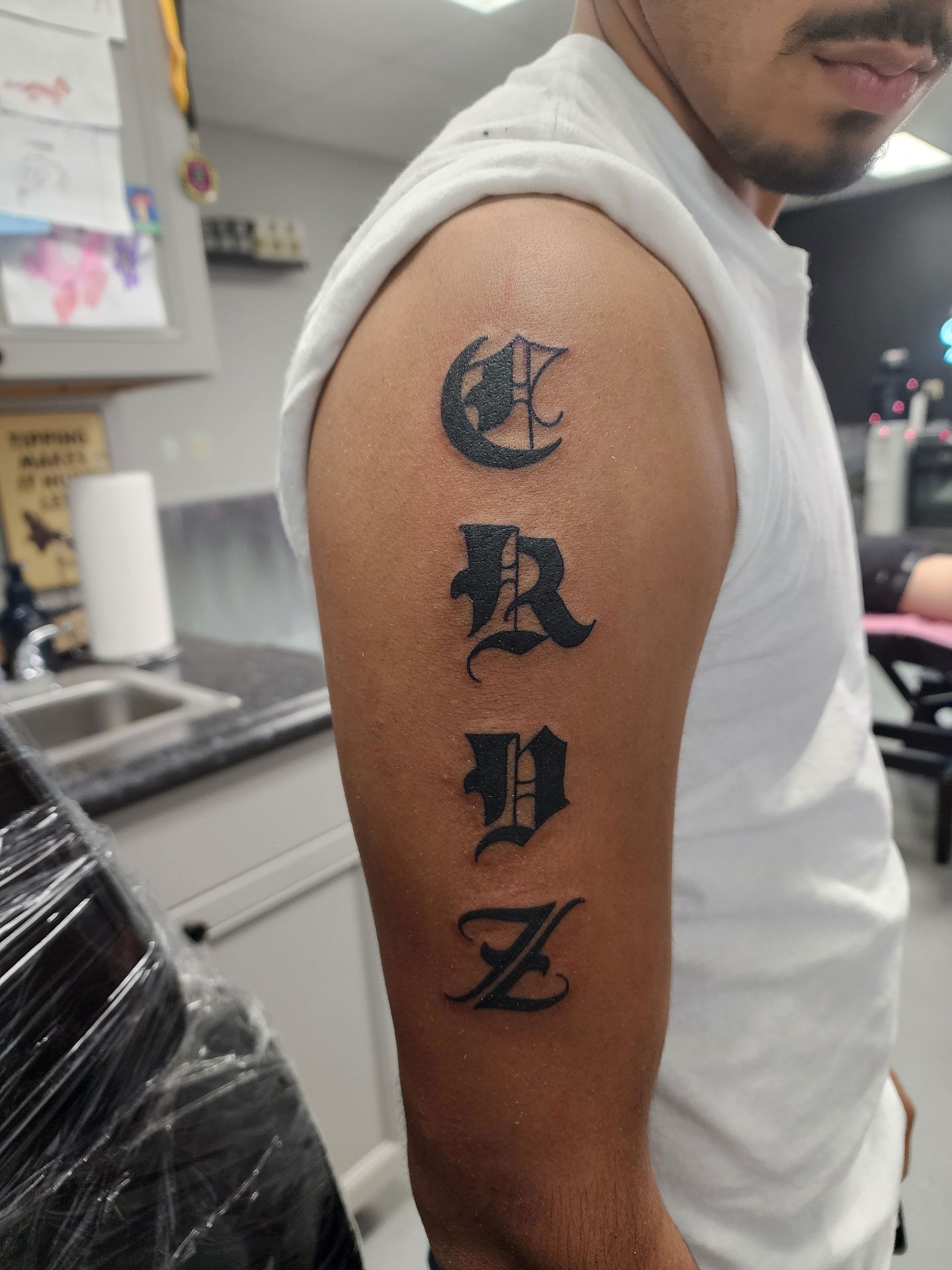 A man has a tattoo on his arm that says 