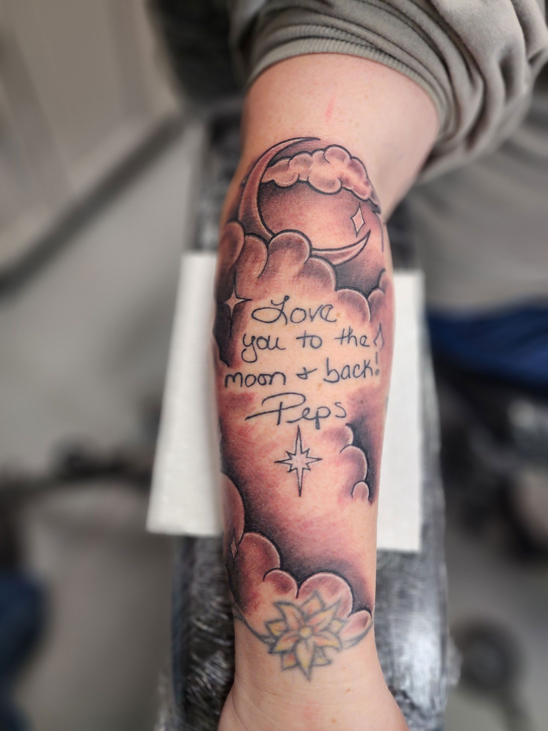 A tattoo on a person's arm that says 