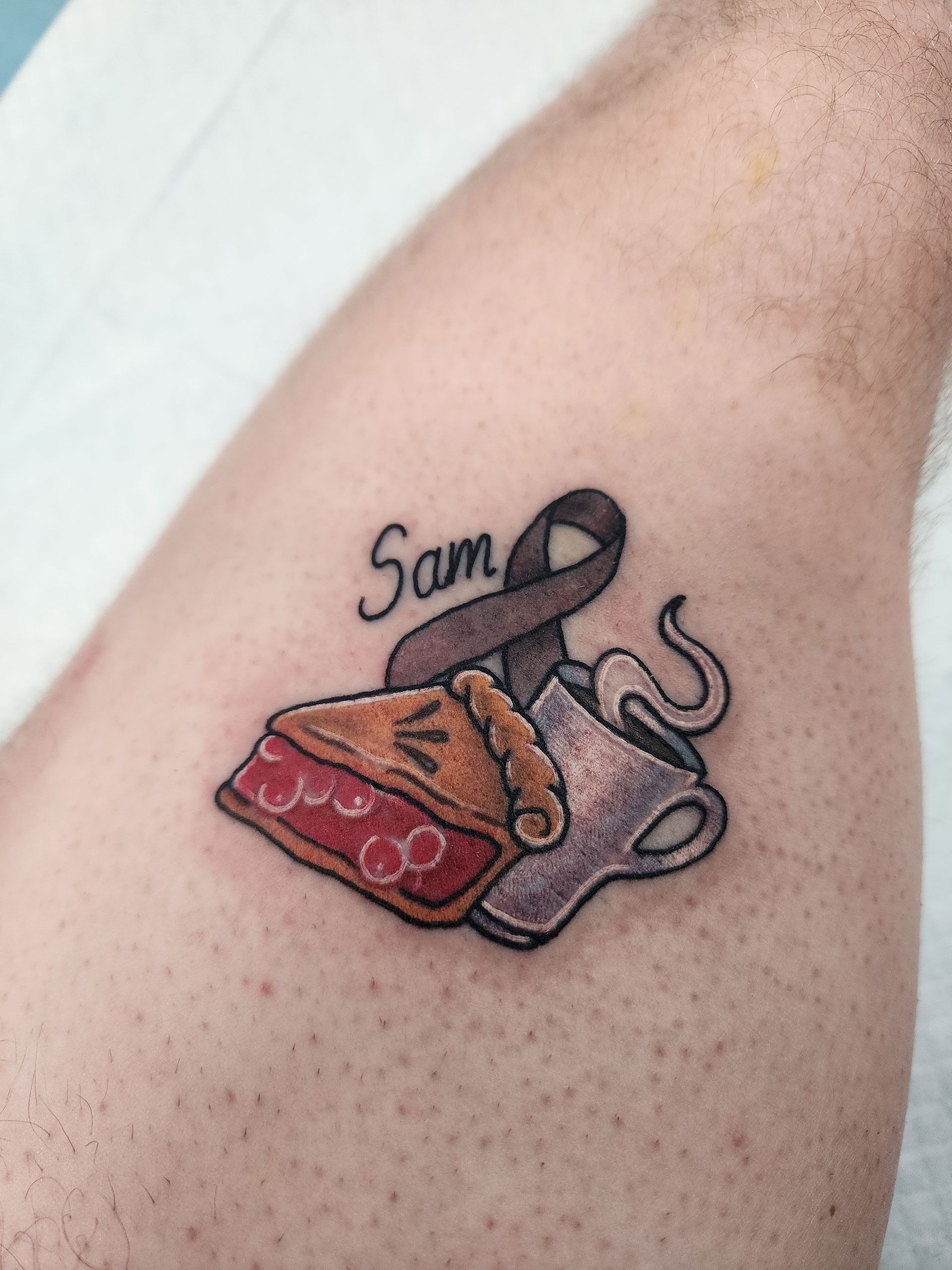 A tattoo on a person's arm that says Sam