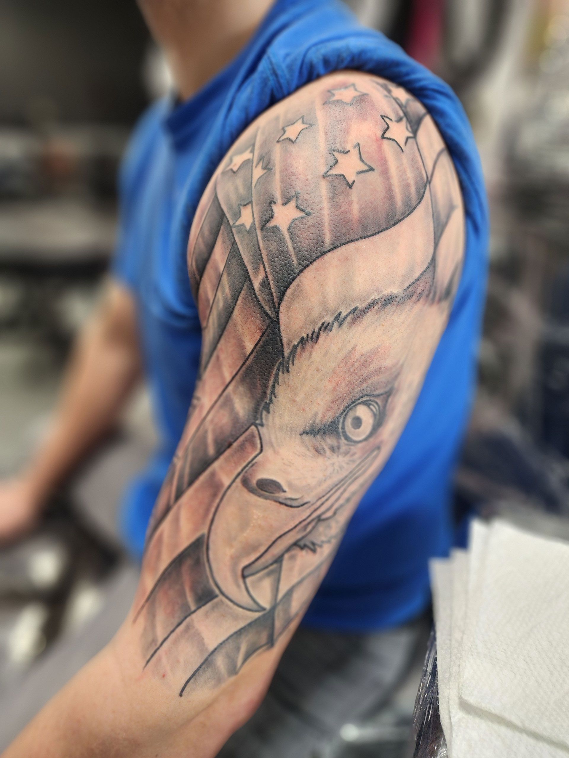 A man has an American flag tattoo on his arm