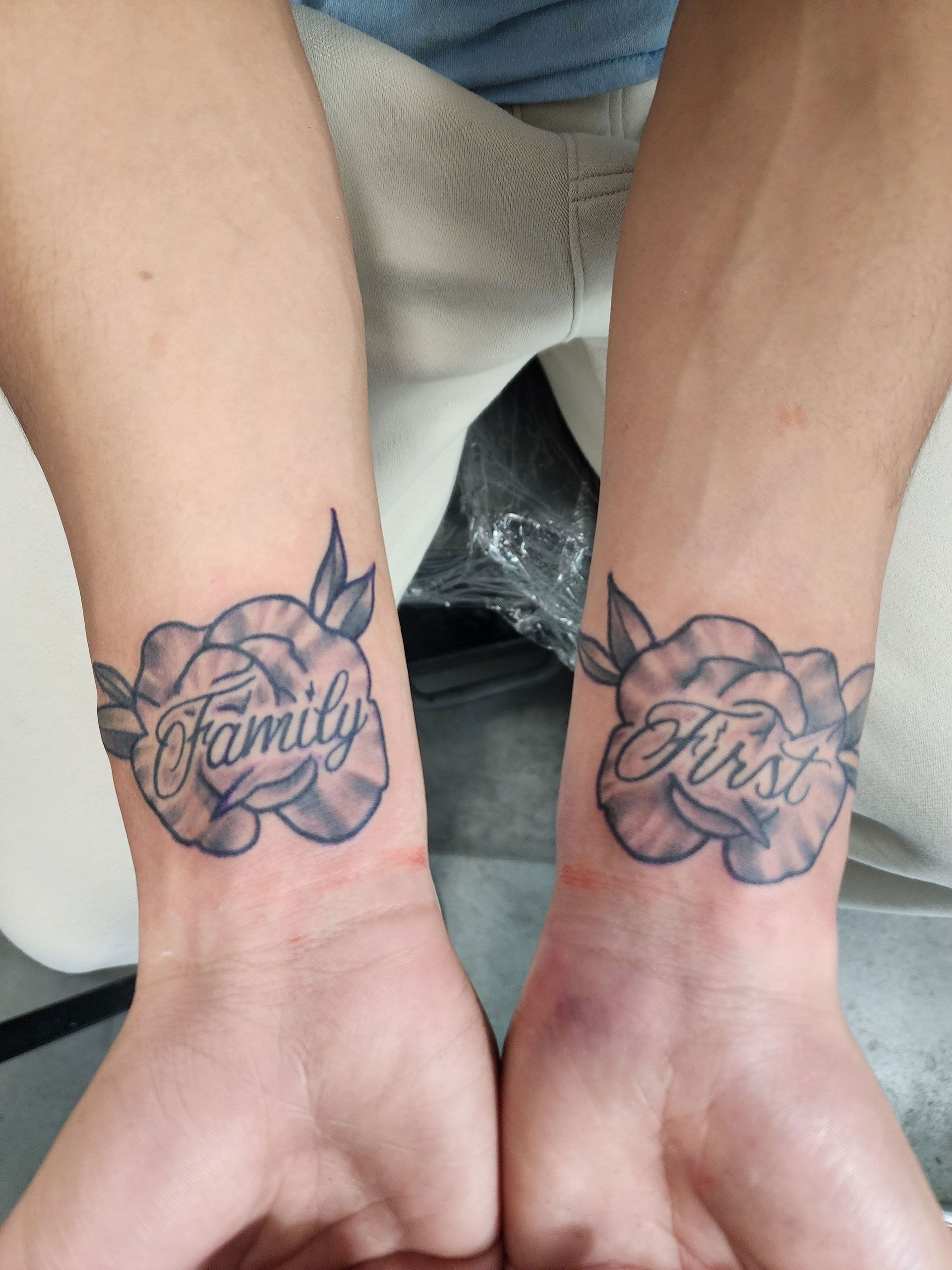 A man has a tattoo on his wrist that says family first