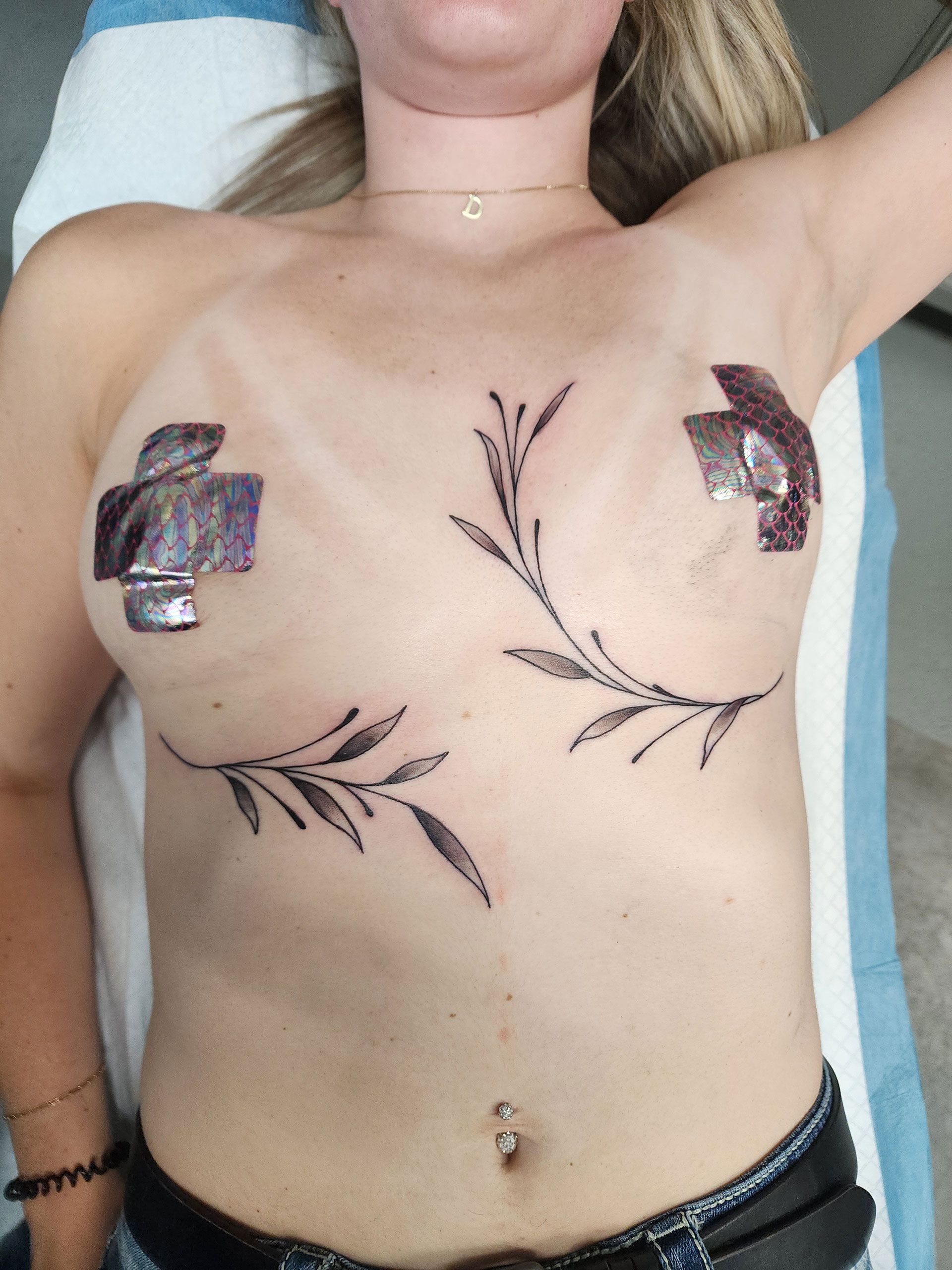 Leaves tattoo surrounding breast area