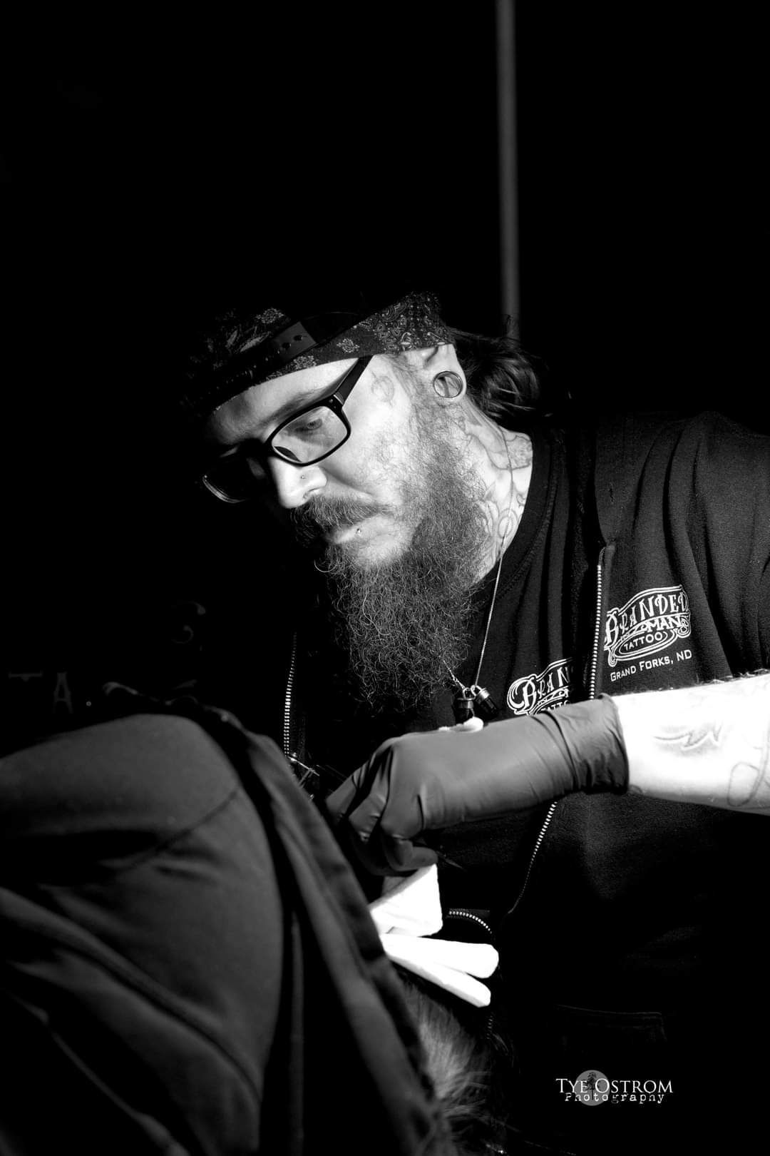 Isaac tatooing a customer