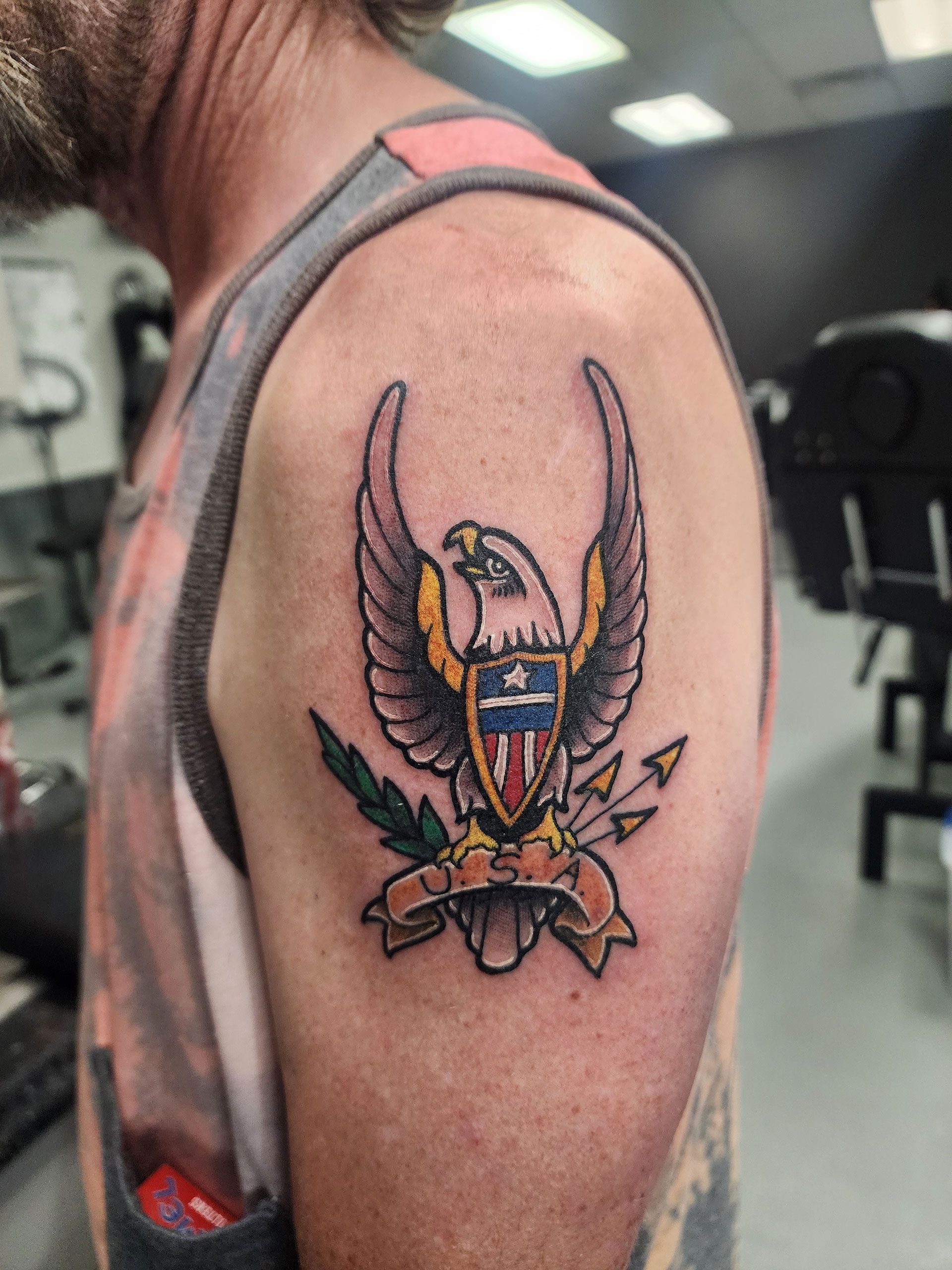 A man has a tattoo of an eagle on his shoulder