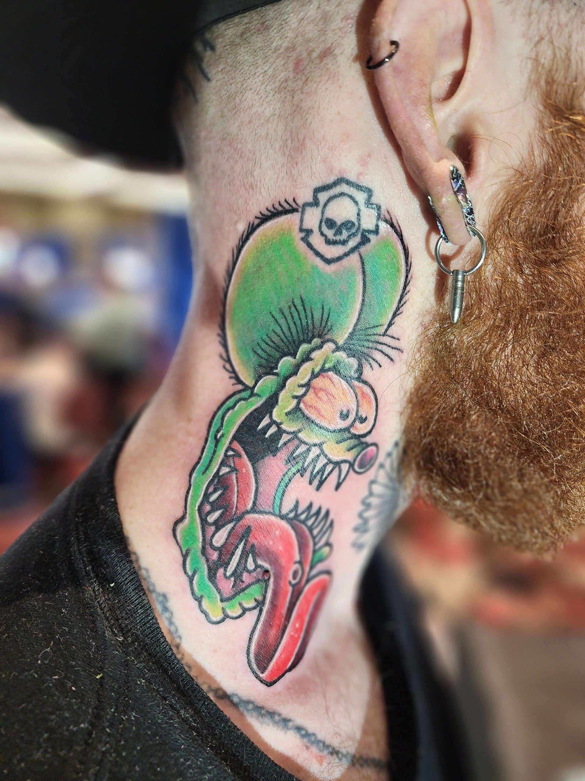 A man with a beard has a tattoo on his neck