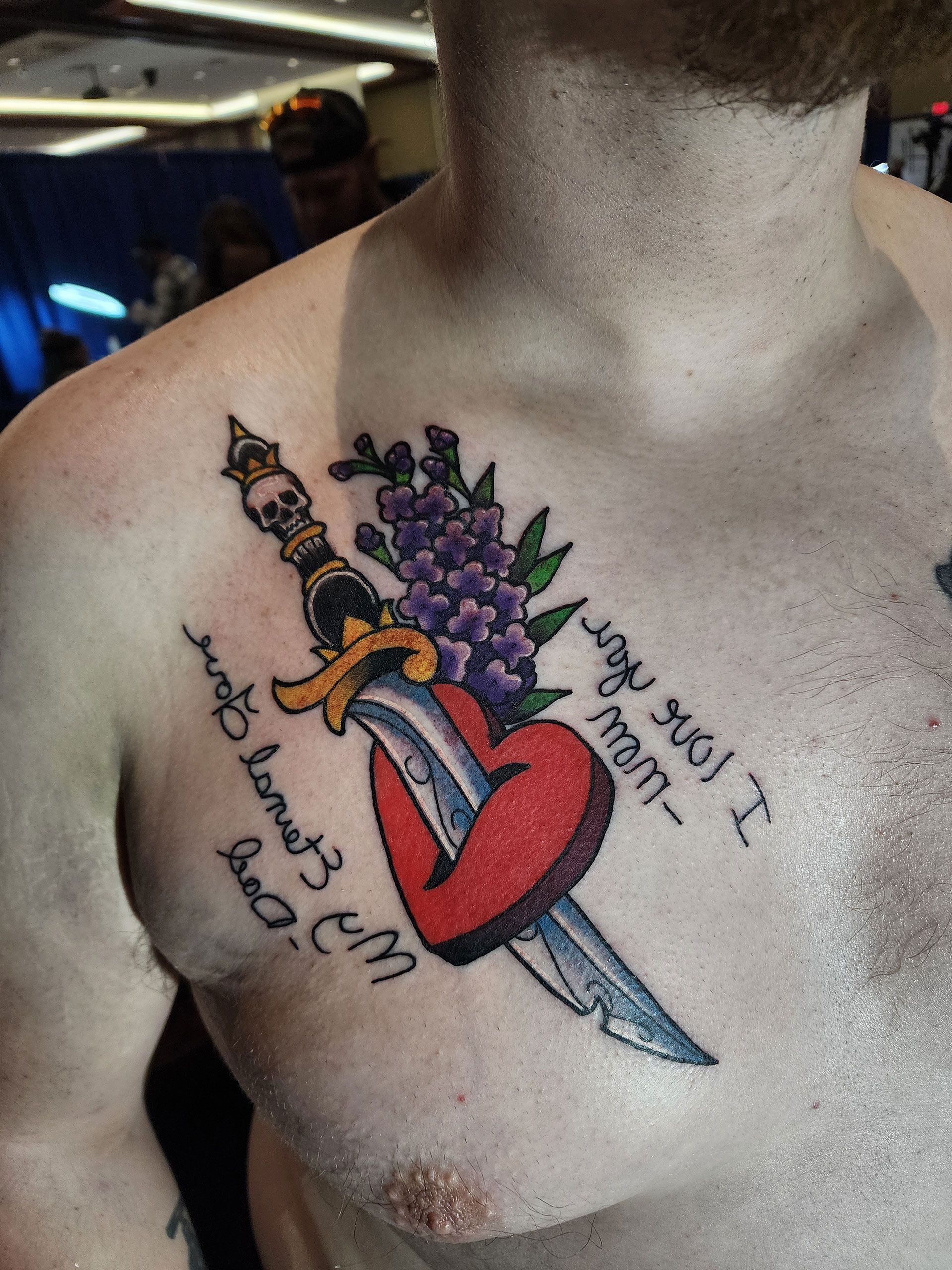 A man has a tattoo on his chest that says 
