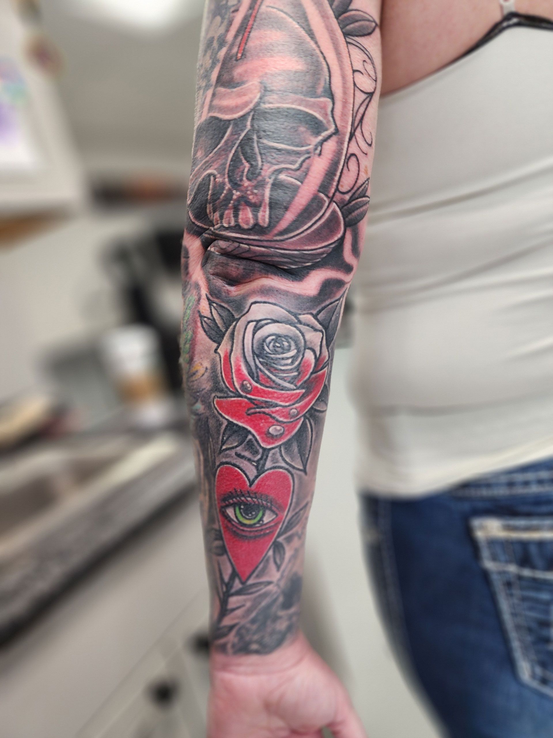 A woman with a full sleeve tattoo on her arm.