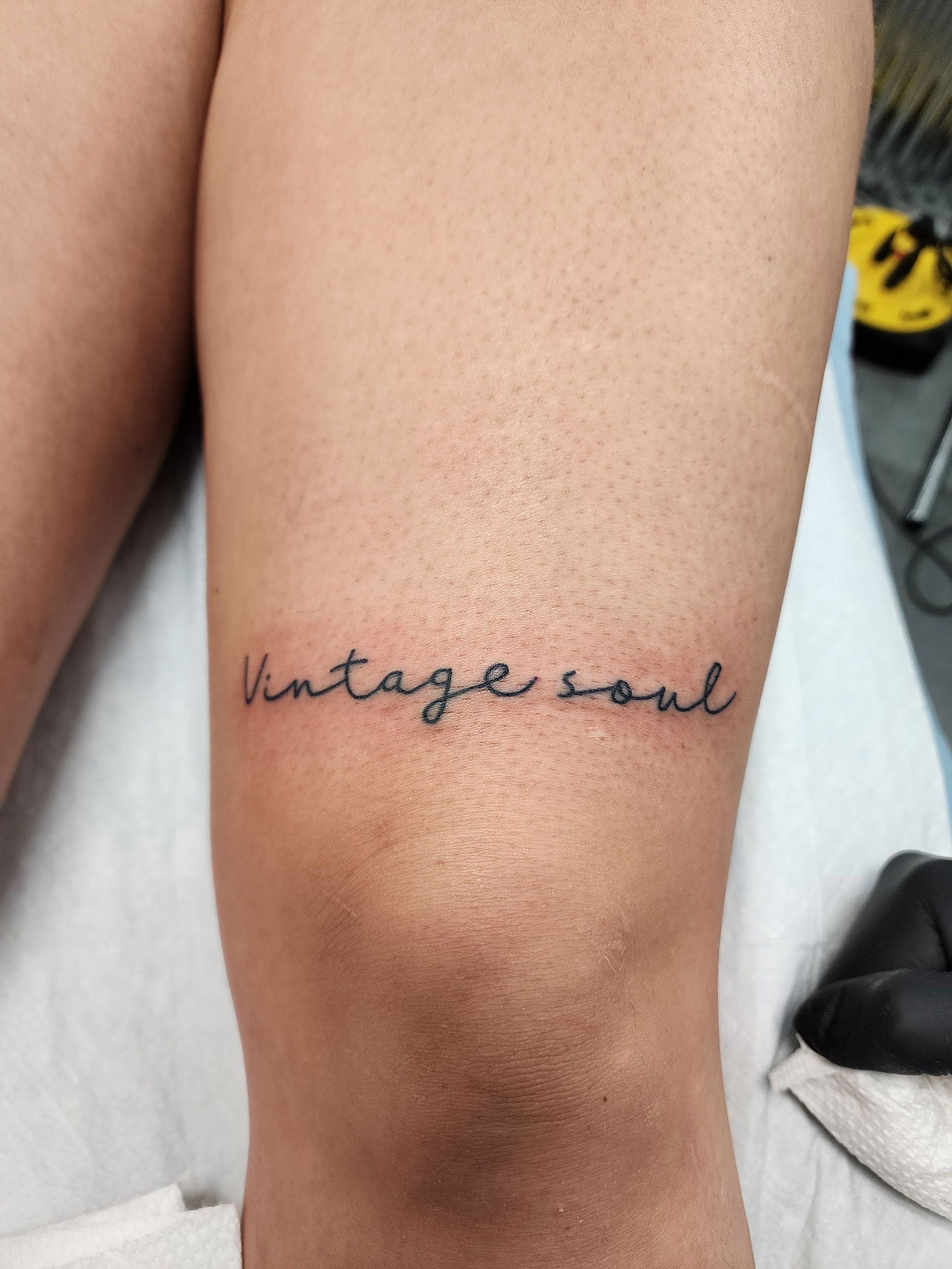 A tattoo on a person's leg that says vintage soul