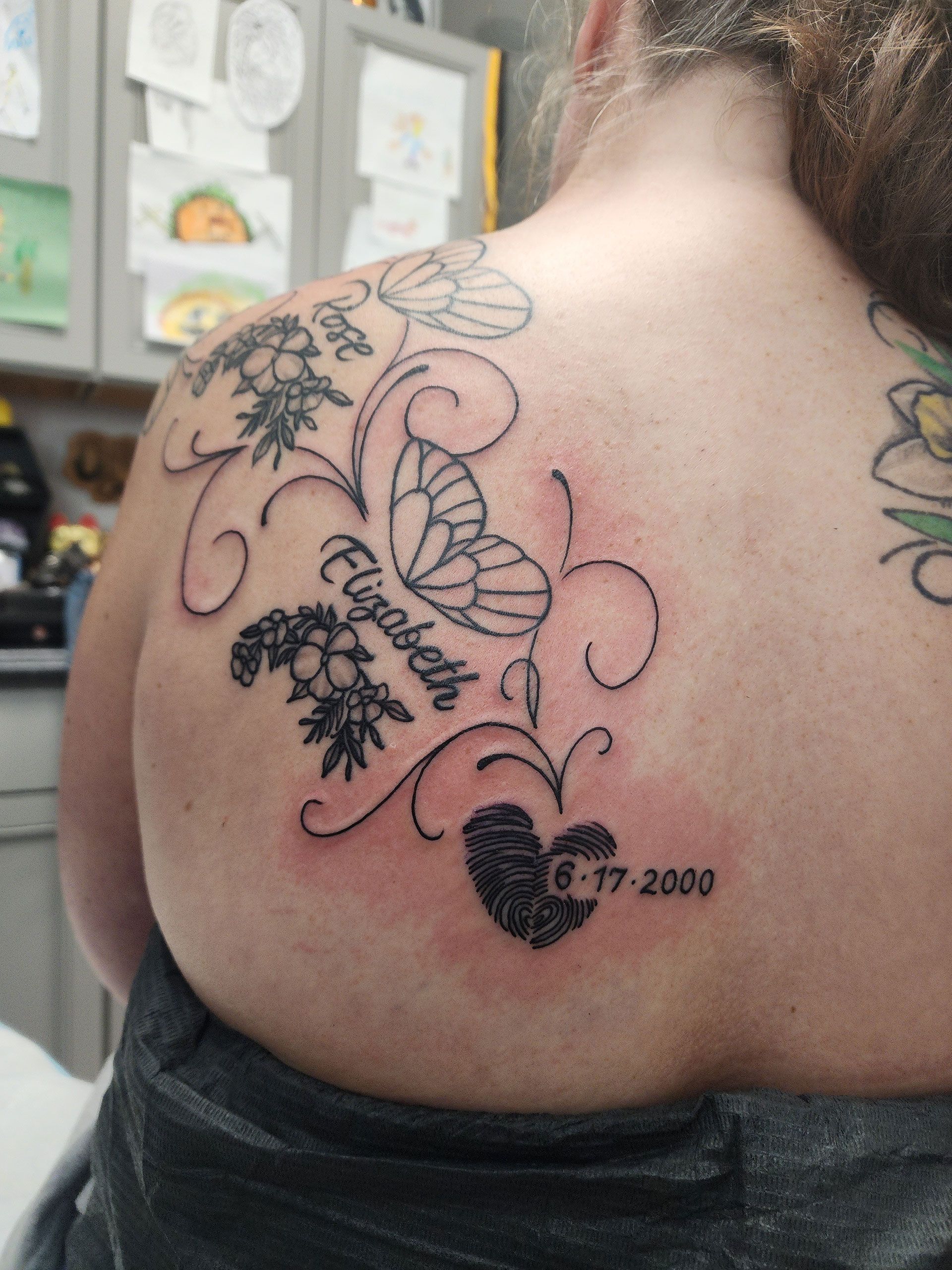 A woman with a tattoo of butterflies and flowers on her back