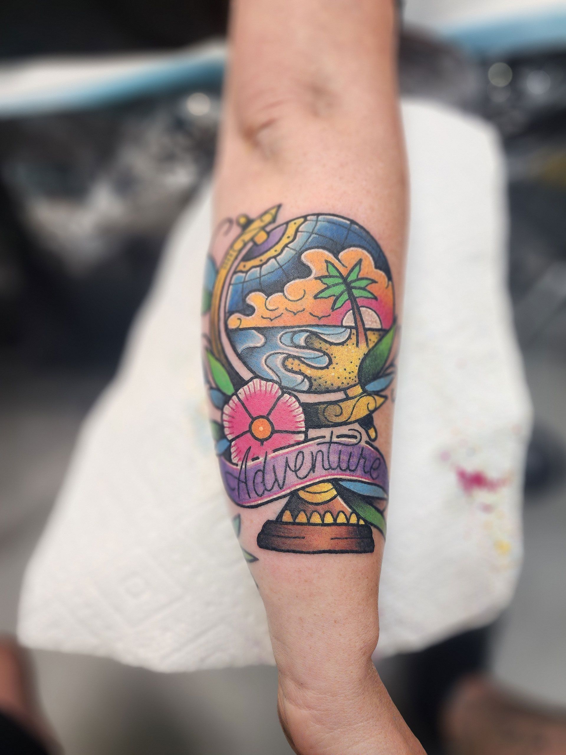 A person has a tattoo on their arm that says 