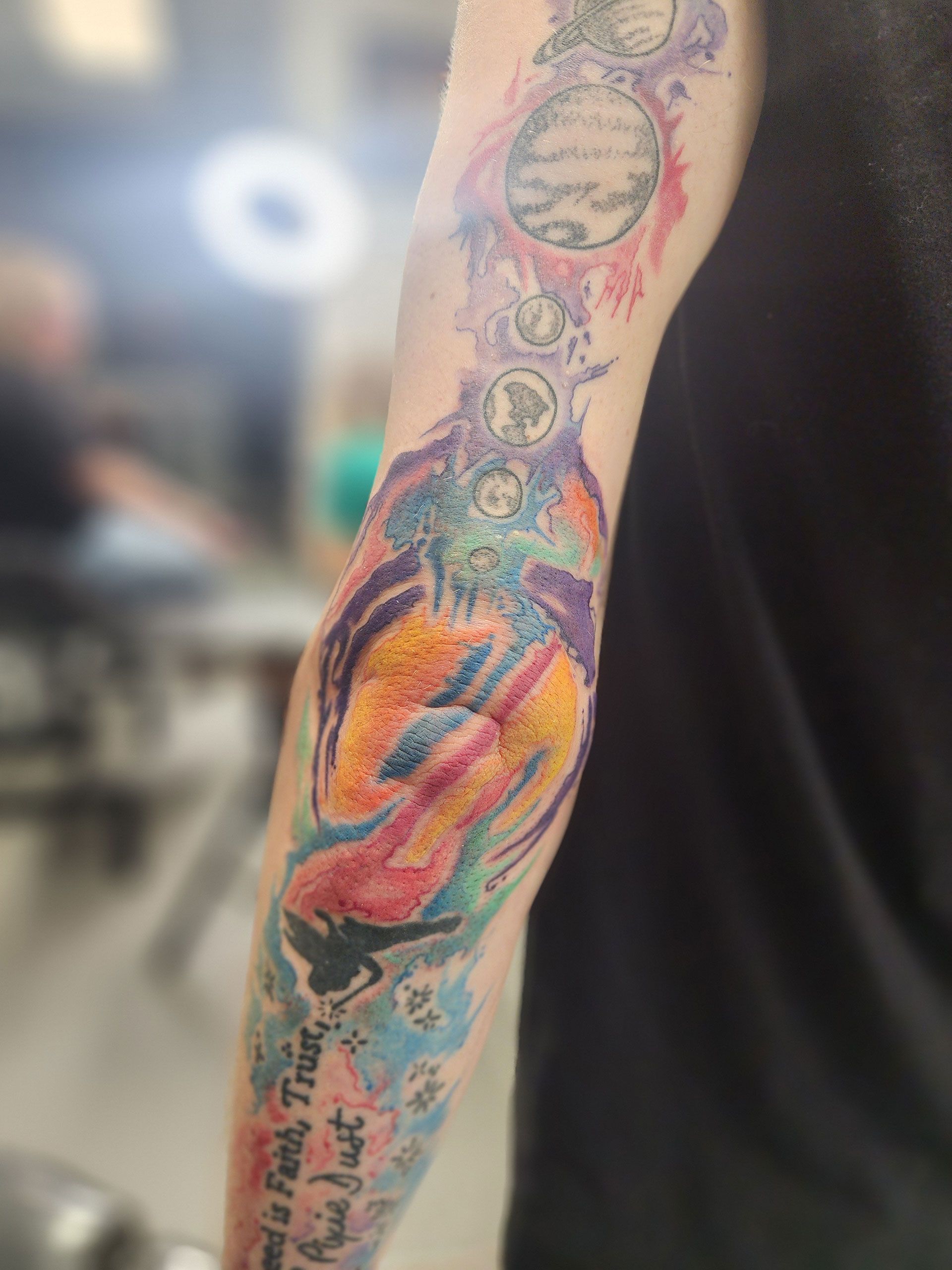 A person with a colorful tattoo on their arm
