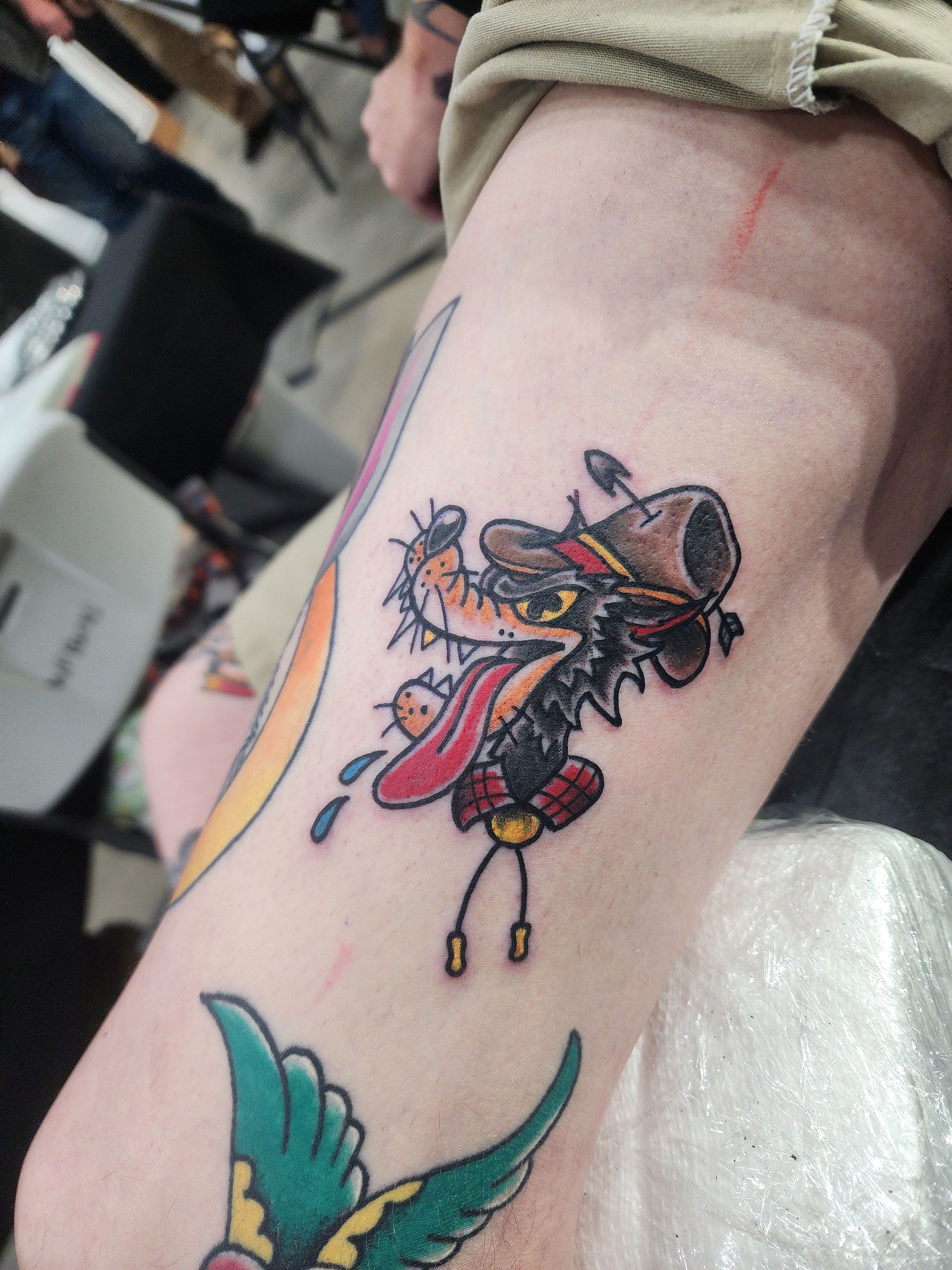 A tattoo of a wolf wearing a cowboy hat