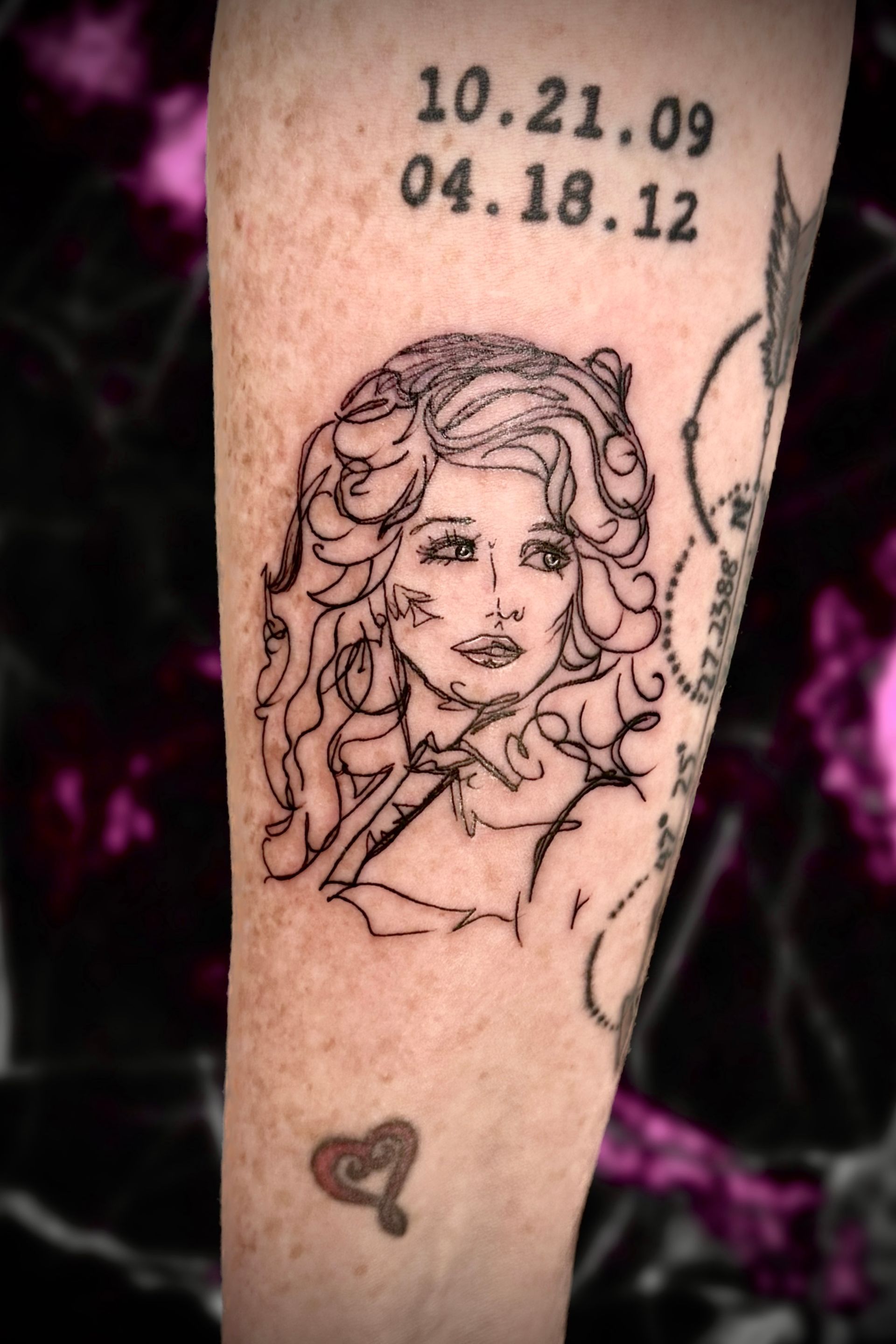 A woman has a tattoo of dolly parton on her leg