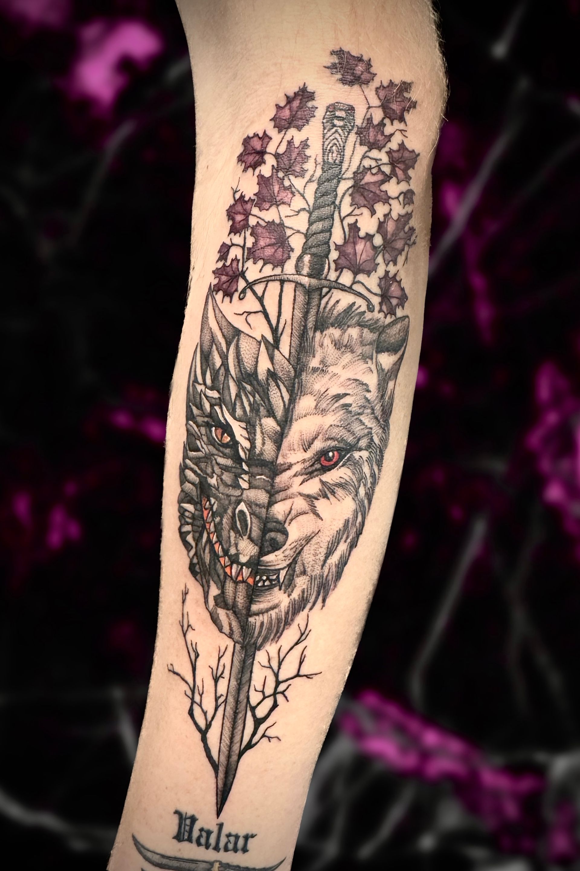 Wolf in a feather silhouette tattoo on arm wrist