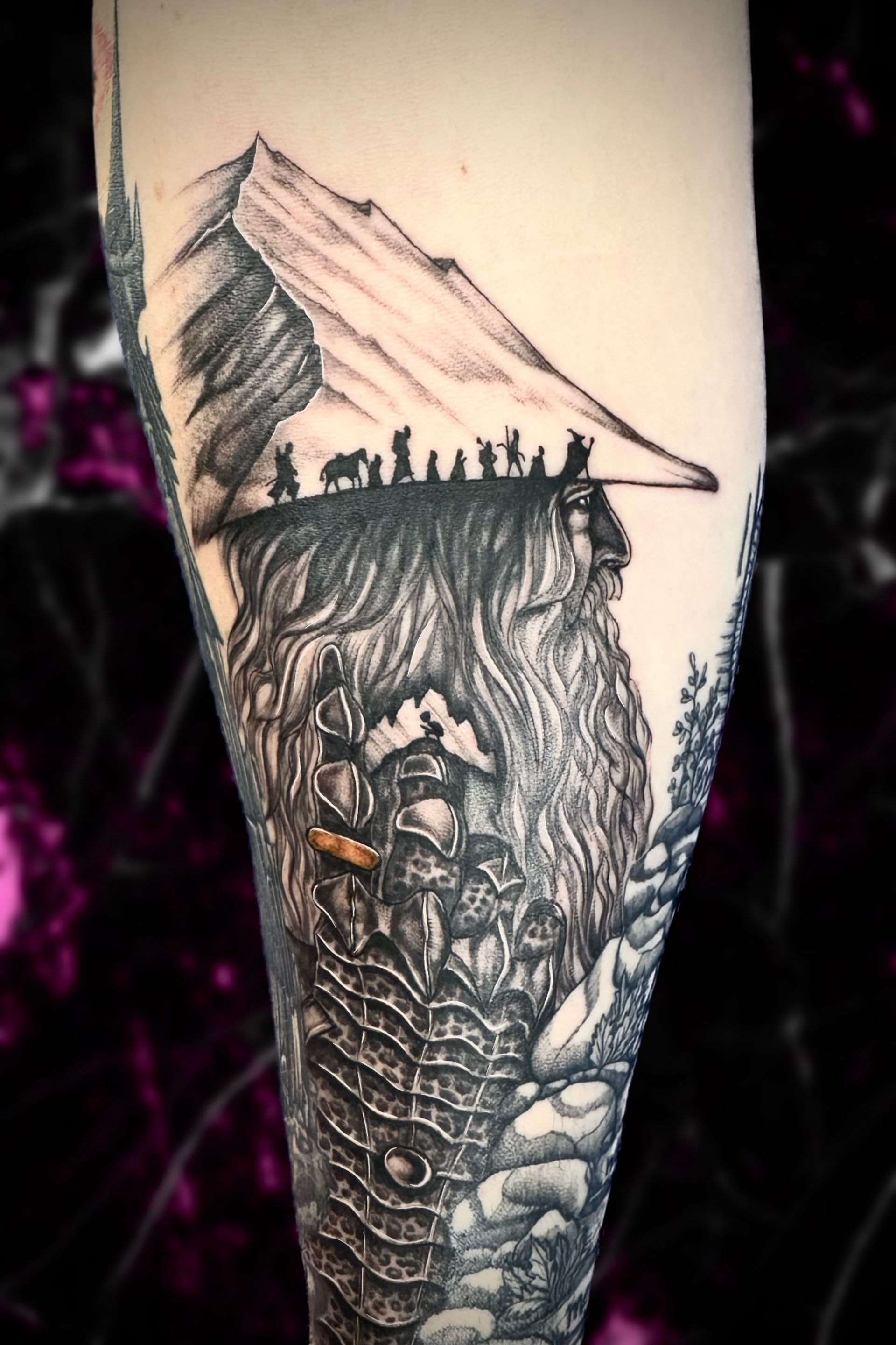 A tattoo of a group of people standing on top of a mountain