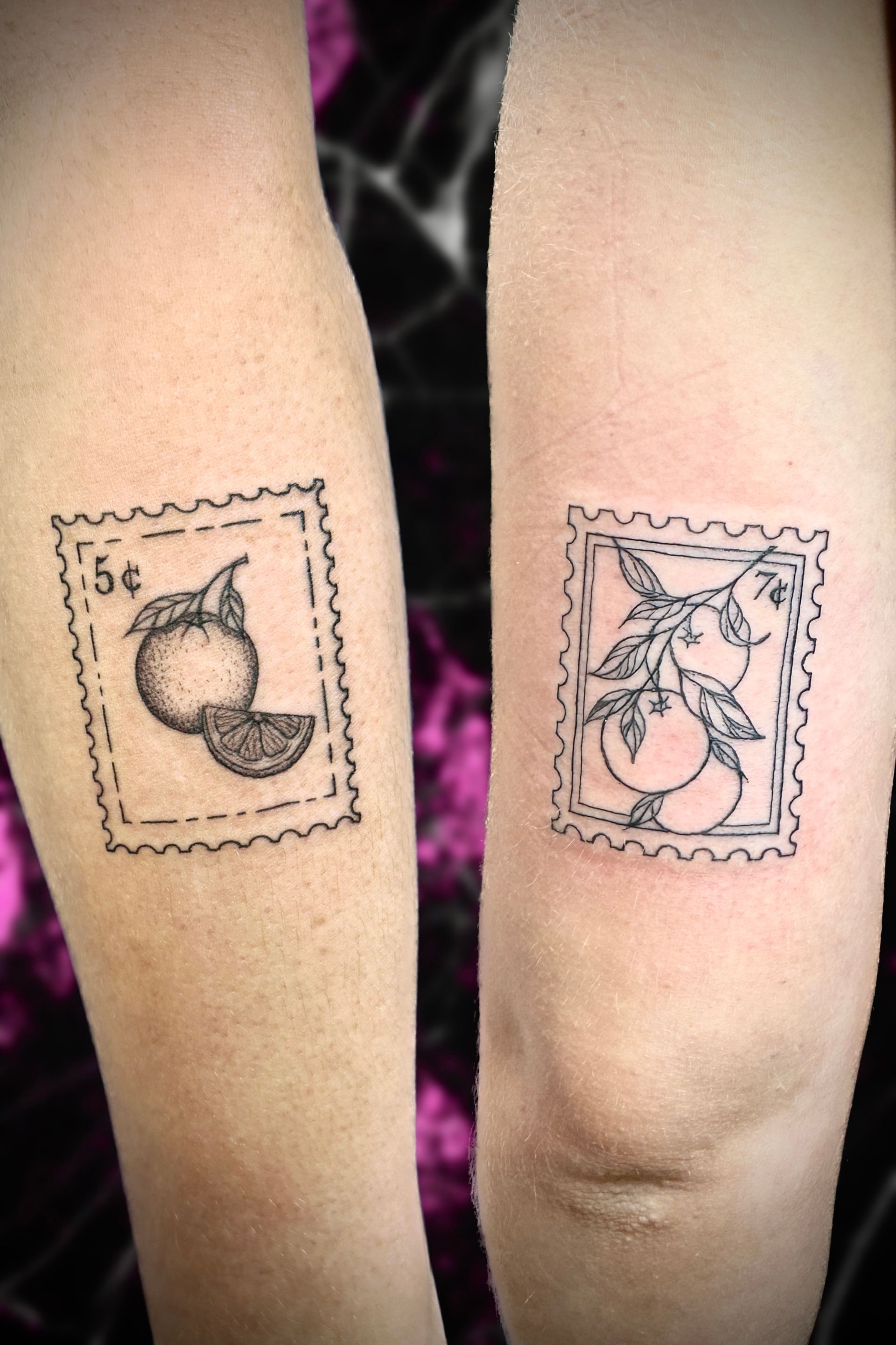 A person has two tattoos on their arms, one of which is a stamp with an orange on it