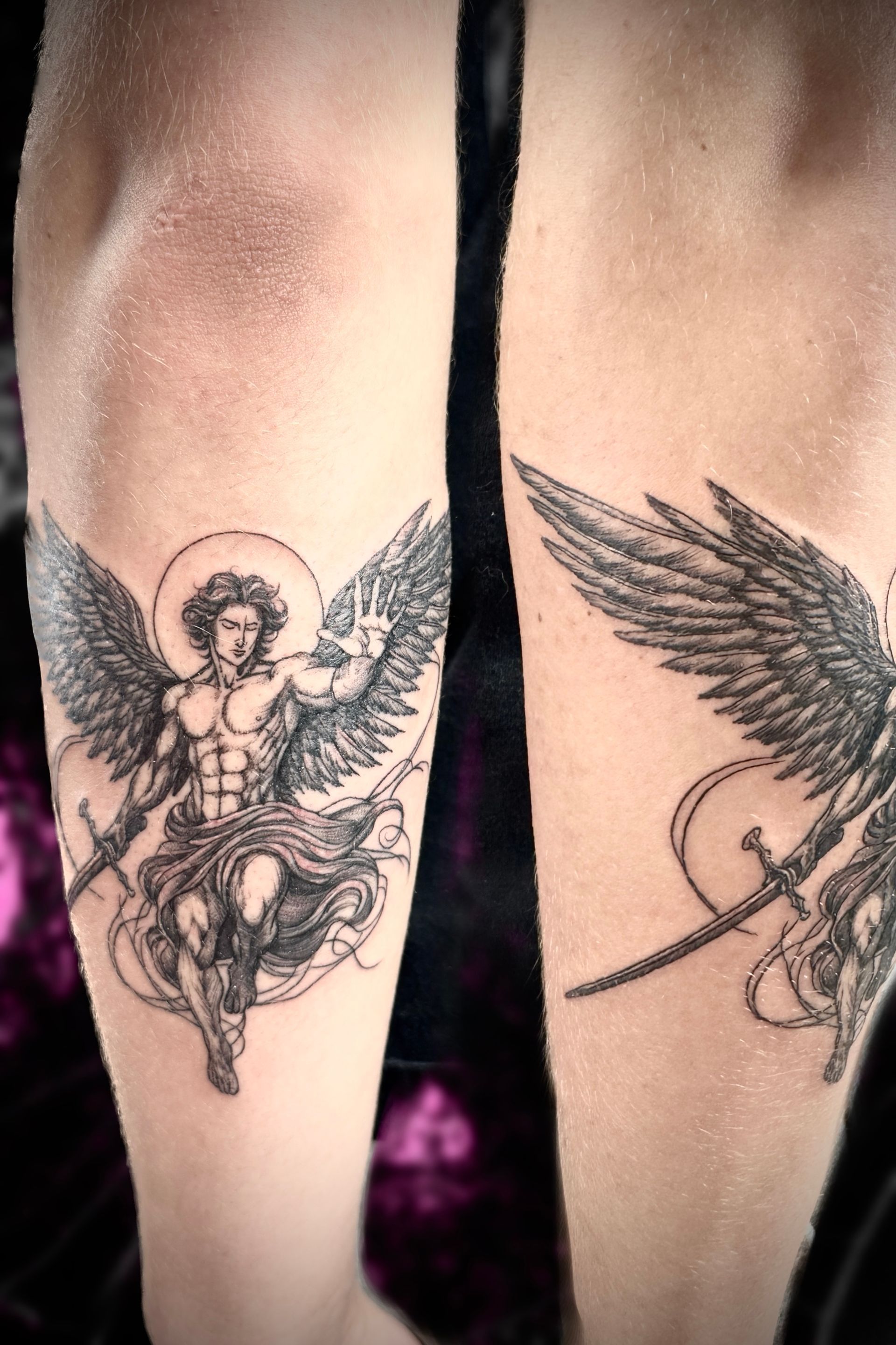 A person has two angel tattoos on their legs
