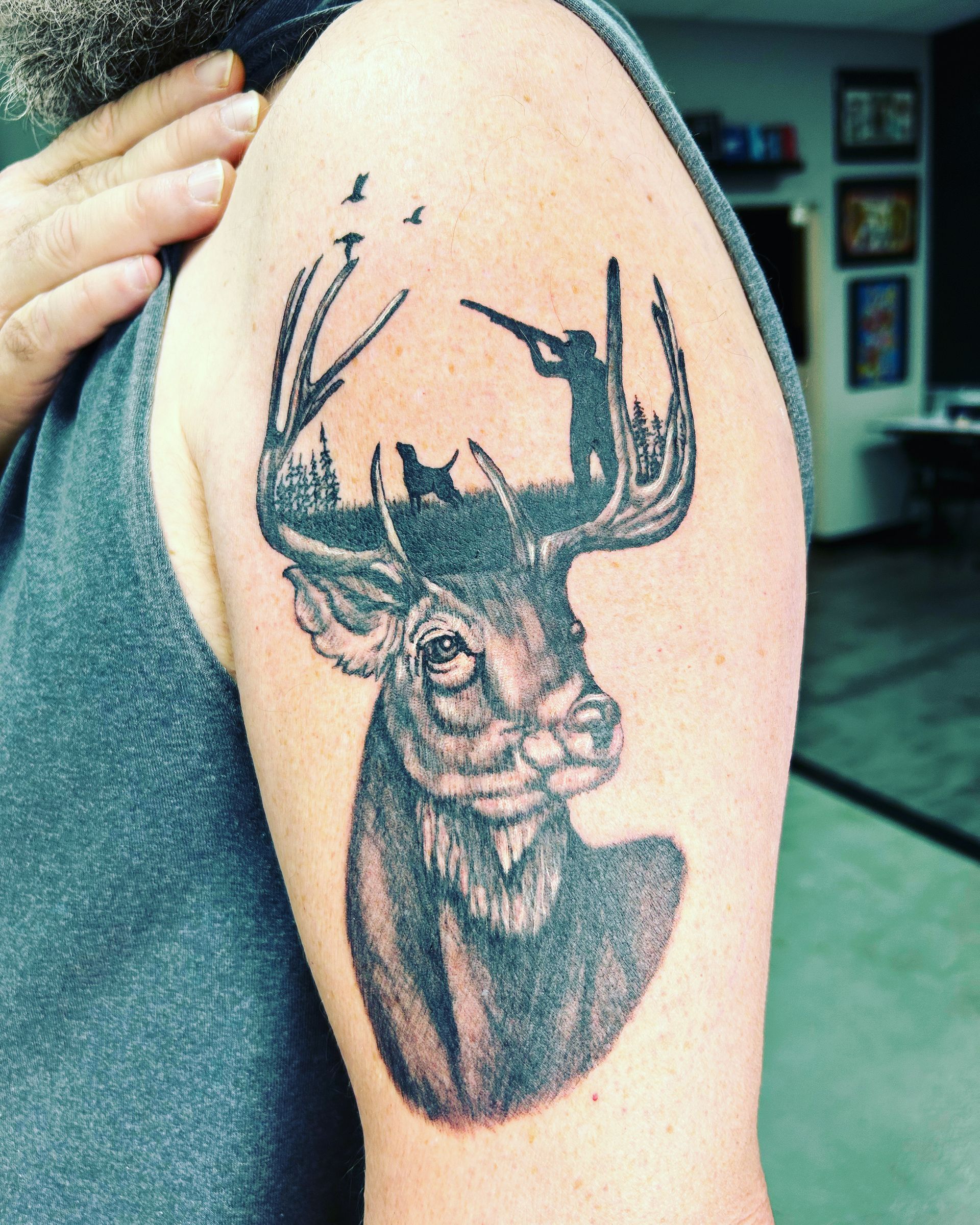 A man has a tattoo of a deer on his arm