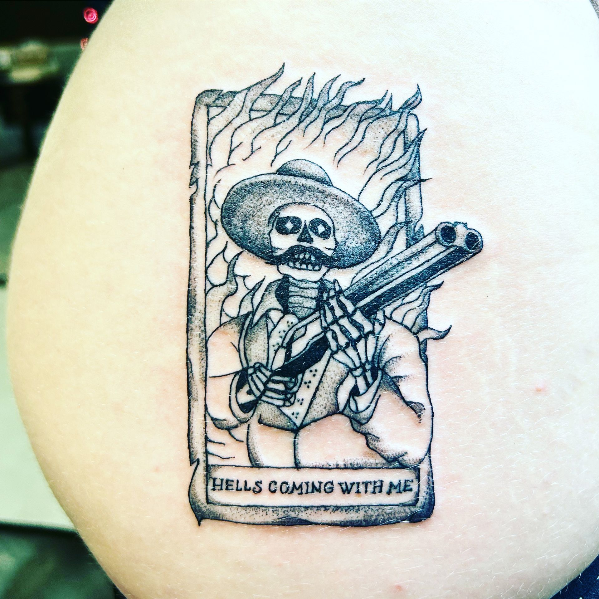 tattoo of a skeleton holding a gun