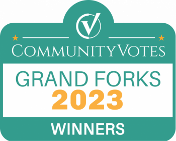 A green sign that says community votes grand forks 2023 winners