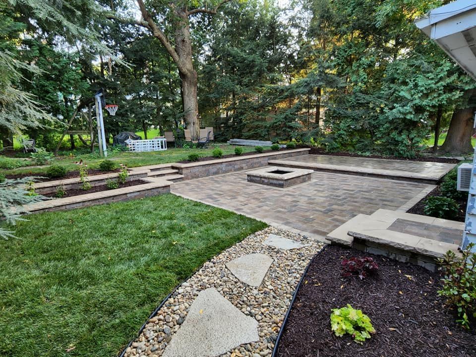 There is a fire pit in the middle of the backyard.