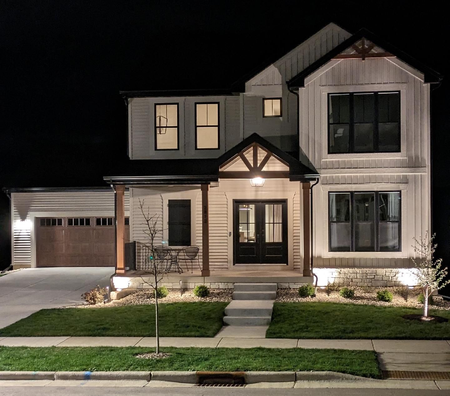 The front of a house is lit up at night