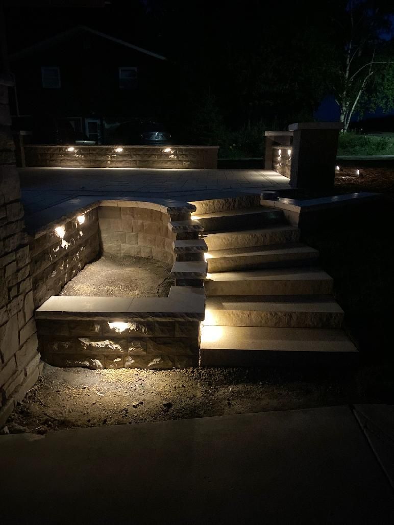 A set of stairs that are lit up at night.
