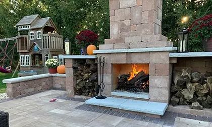 Learn More About Design Services A large house with a patio and stairs in the backyard.