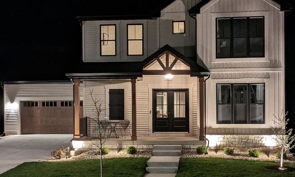 The front of a house is lit up at night.