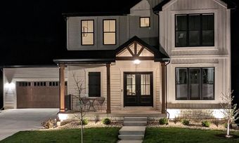 The front of a house is lit up at night.