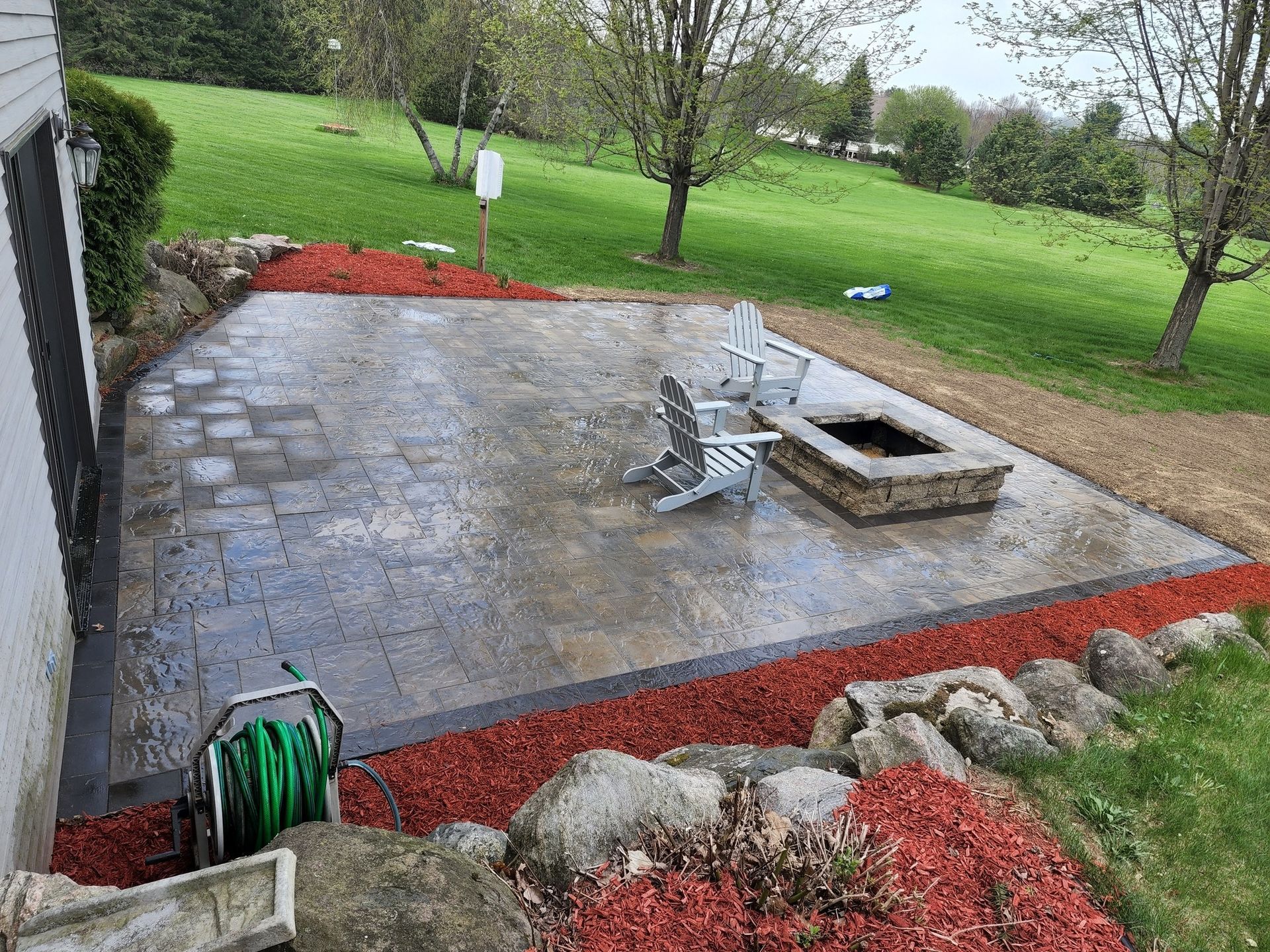 There is a fire pit in the middle of the patio.