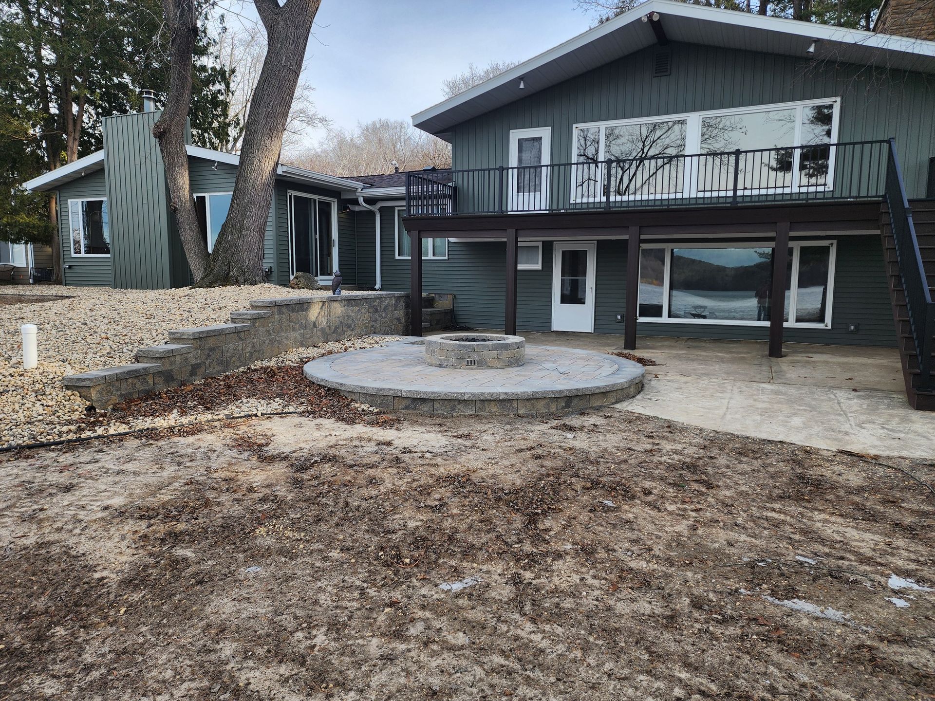 A large house with a fire pit in front of it.