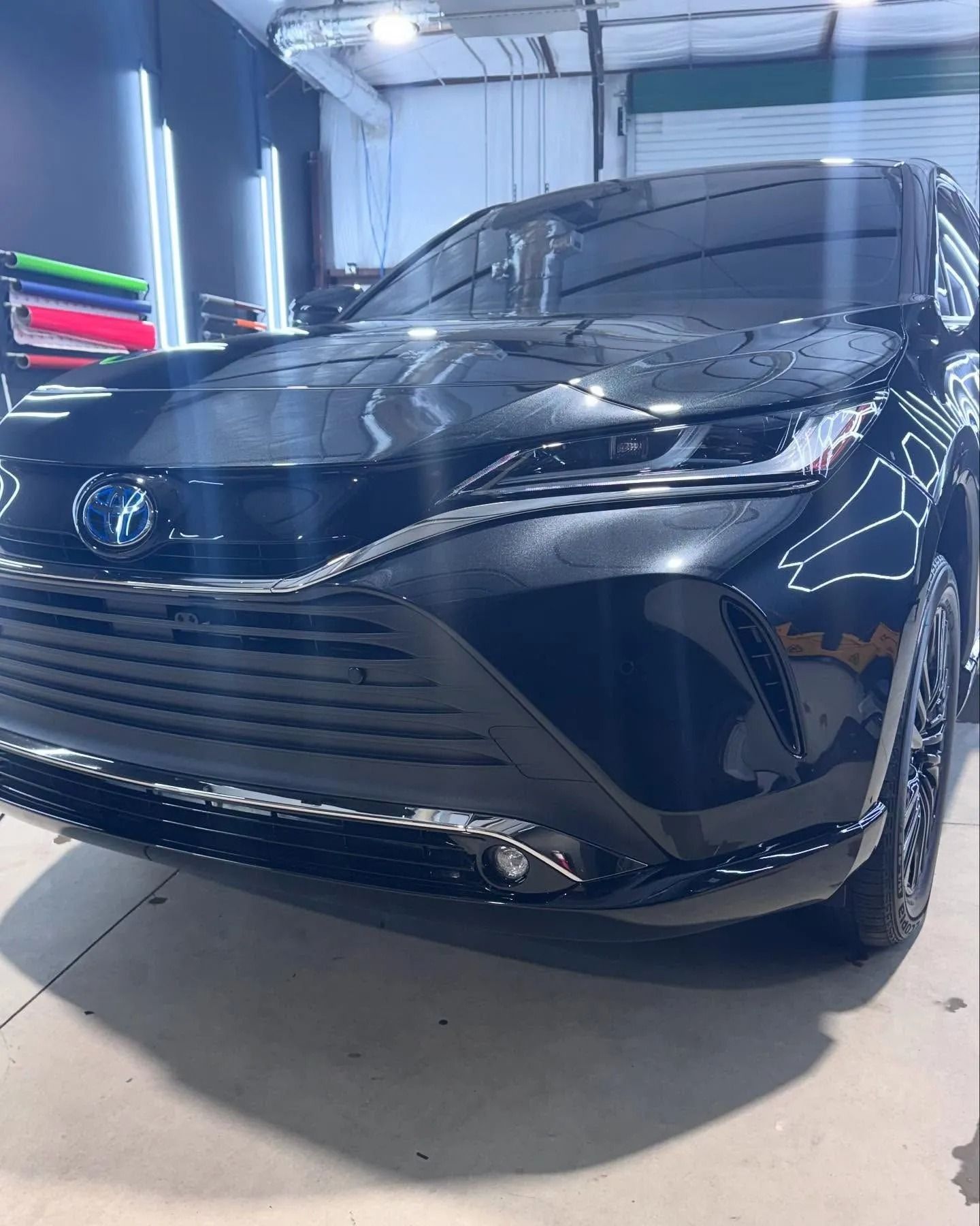 Black Toyota Venza Hybrid SUV, inside a garage, freshly detailed and gleaming.