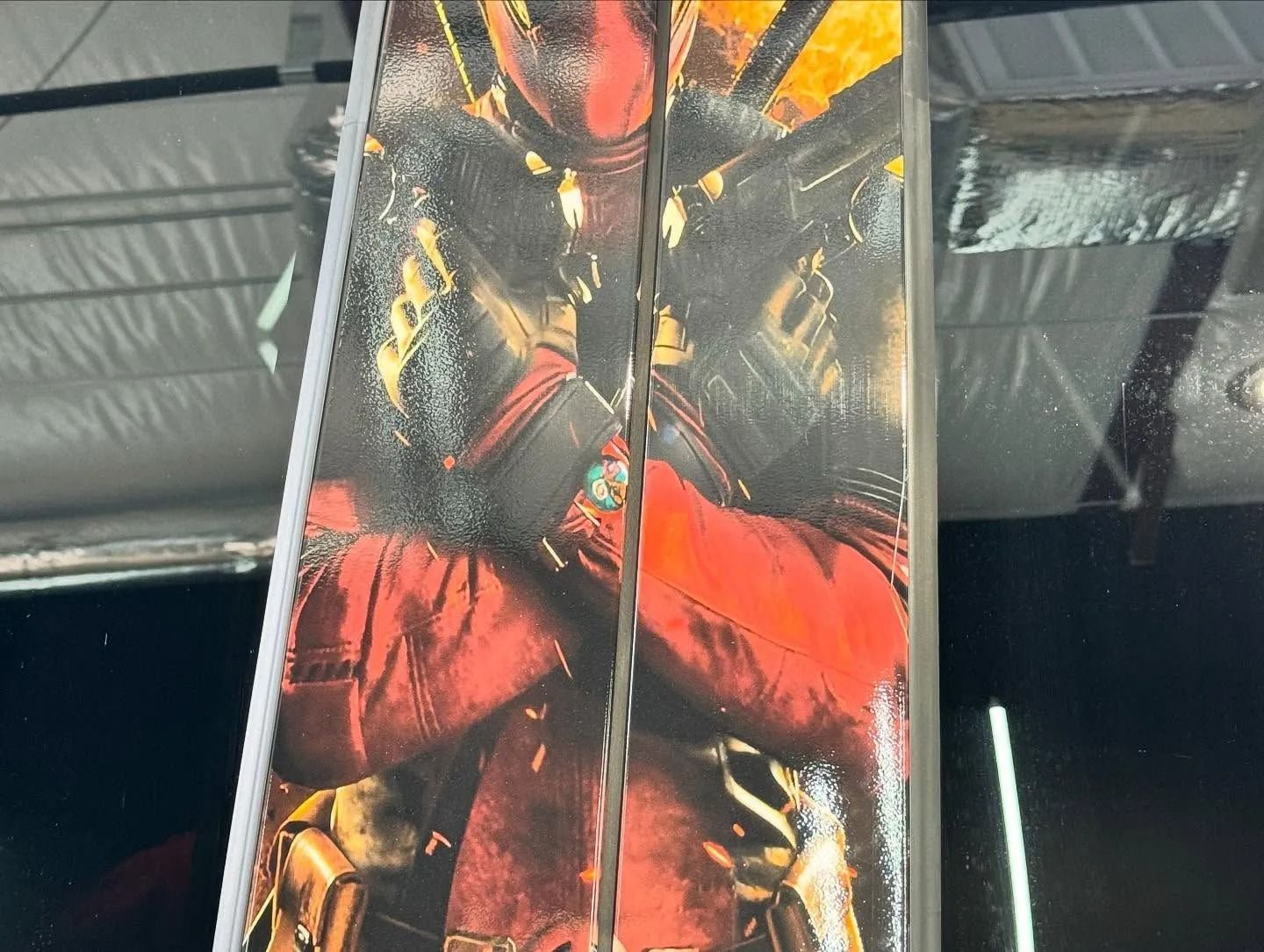 Two action figure boxes side-by-side with Deadpool artwork. Mostly red and black.