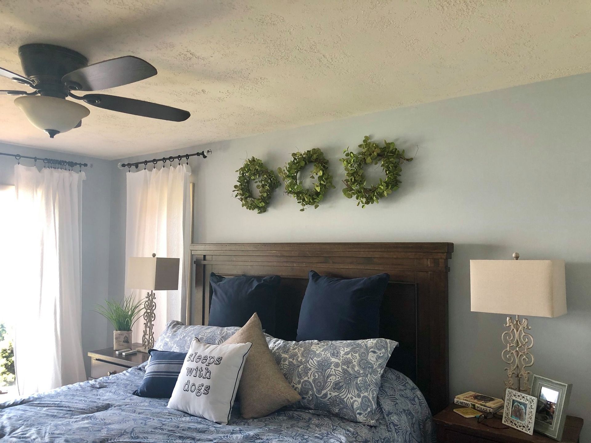 A bedroom with a bed and a ceiling fan