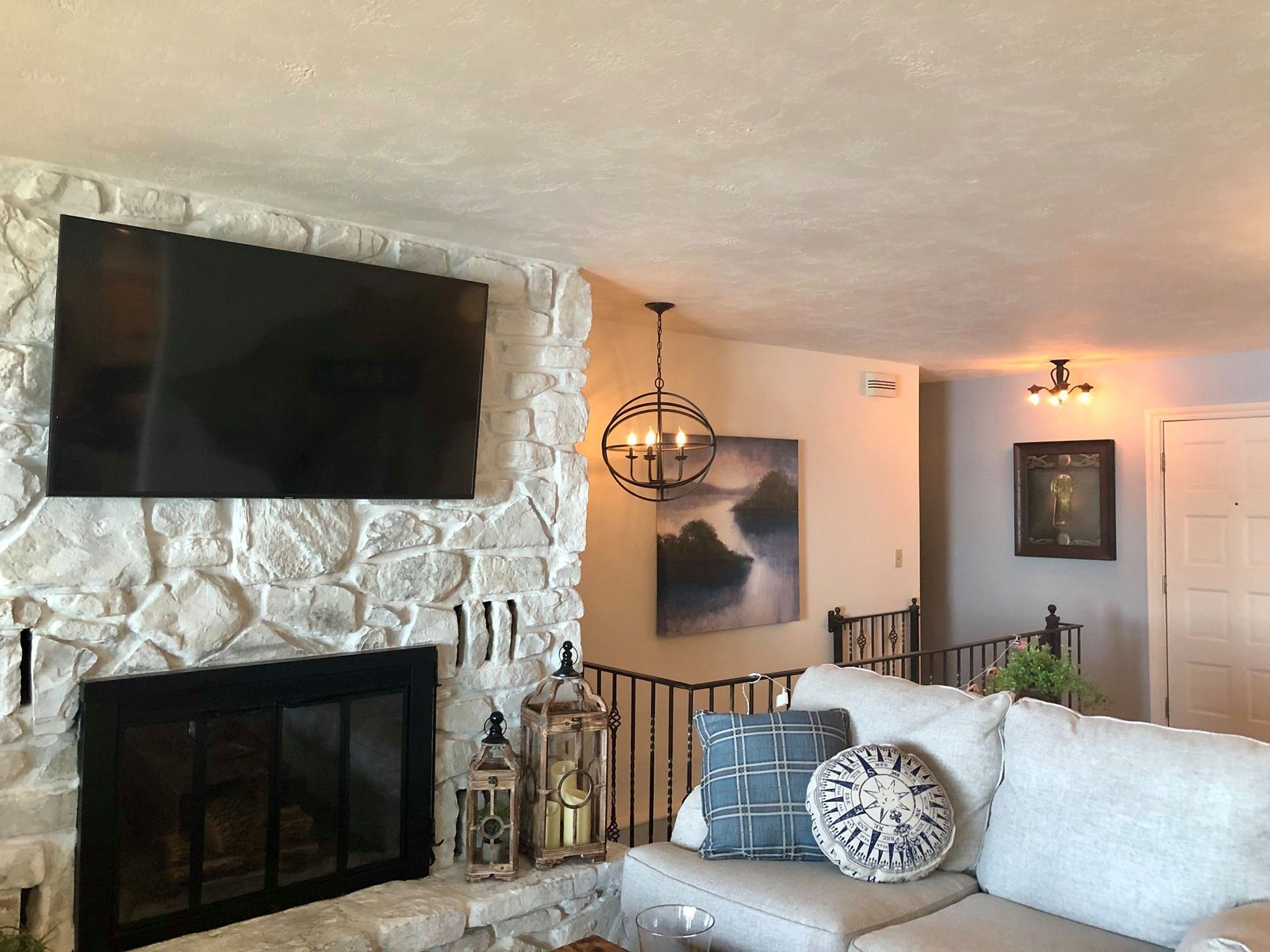 A living room with a fireplace and a flat screen tv