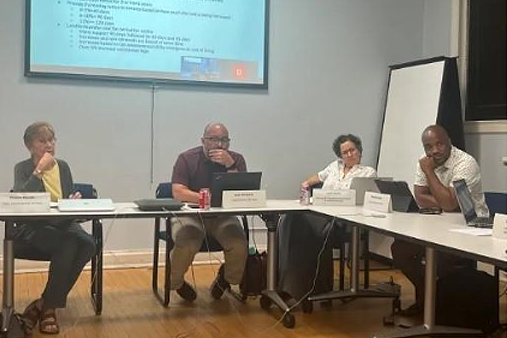 A group of people sitting in front of the table.