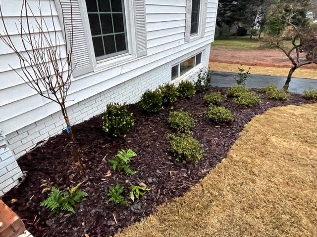 a white house with a garden in front of it .